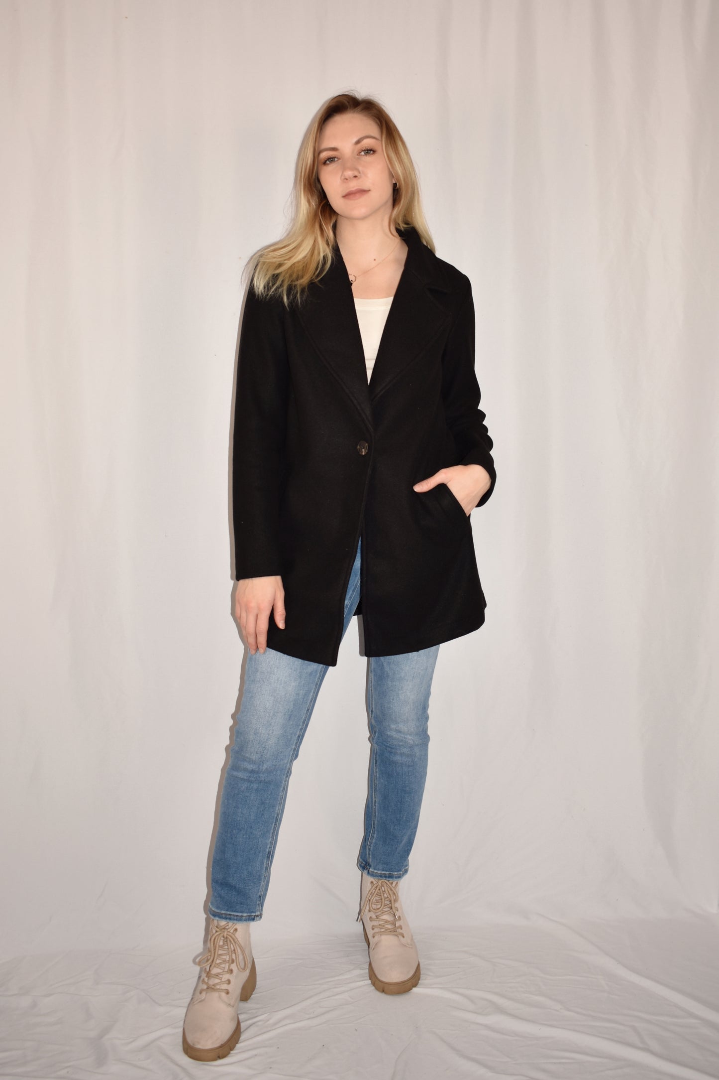classic pea coat with side pockets, one button enclosure, hip length.