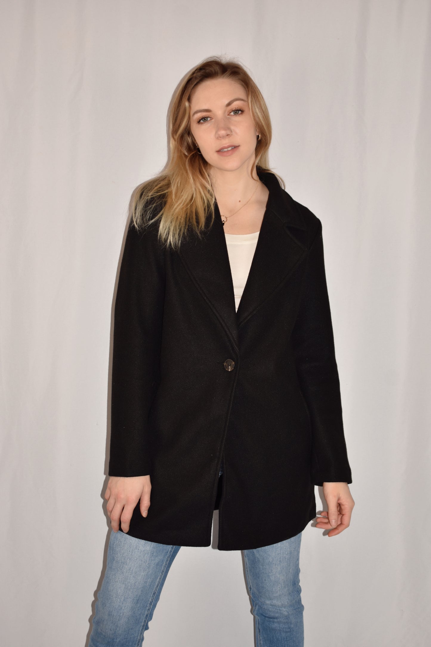 classic pea coat with side pockets, one button enclosure, hip length.