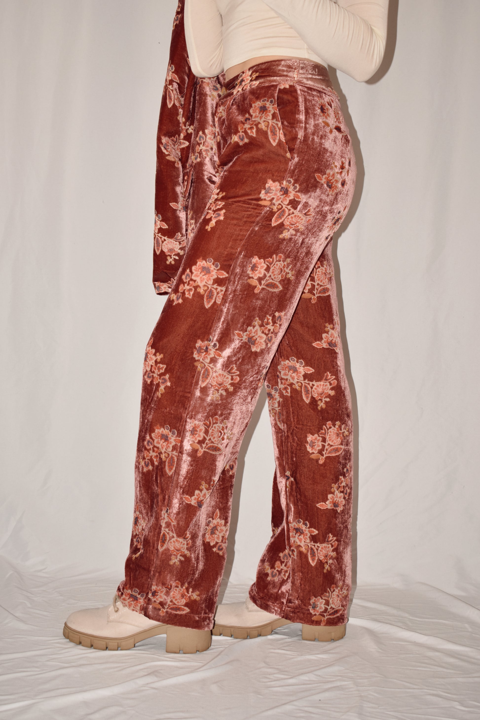 Mauve velvet straight leg trousers with side pockets and zip and button front enclosure. floral pattern. full length.