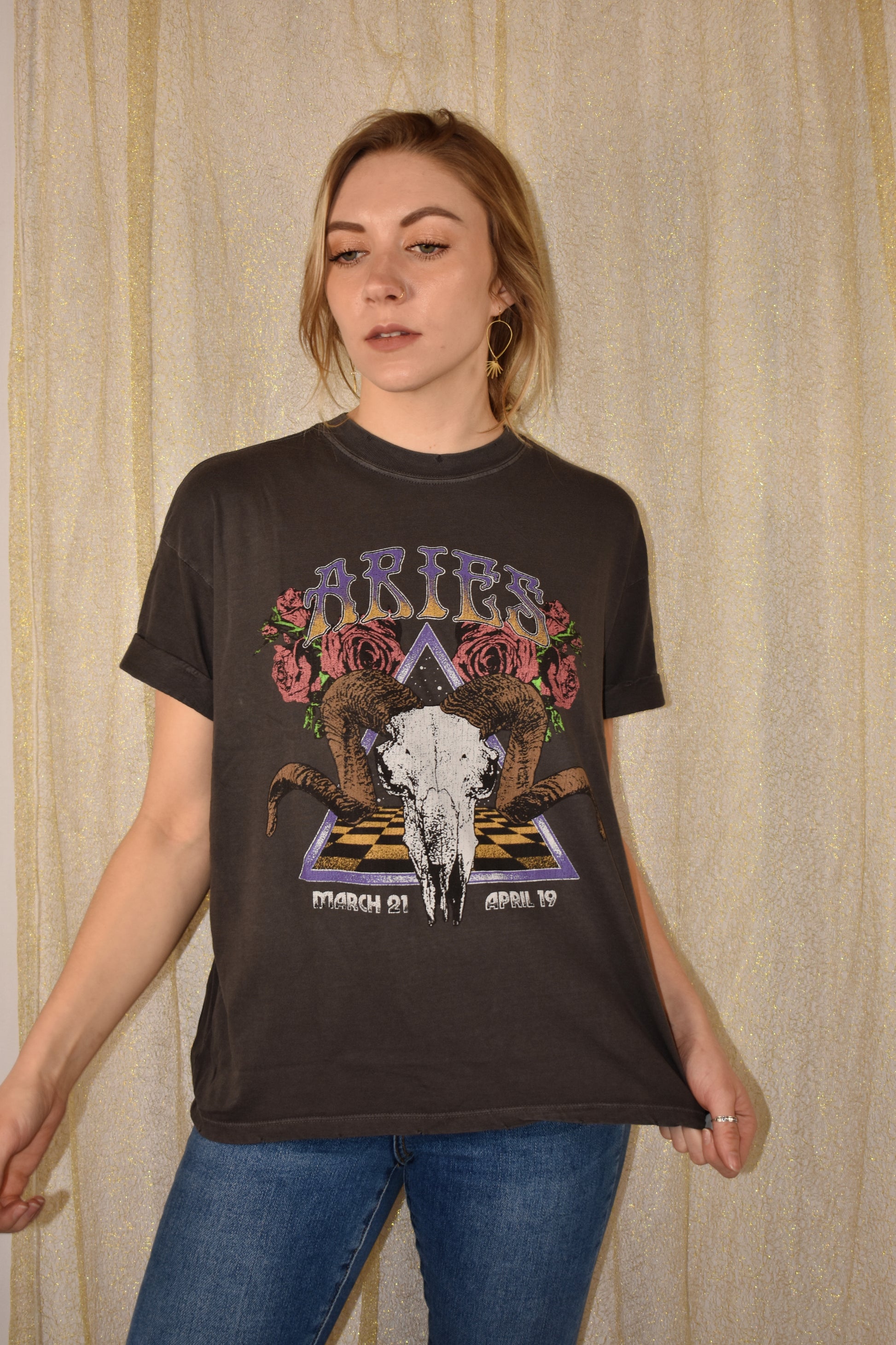 slightly oversized zodiac tee with grungy design and cuffed short sleeves. tshirt color is dark gray
