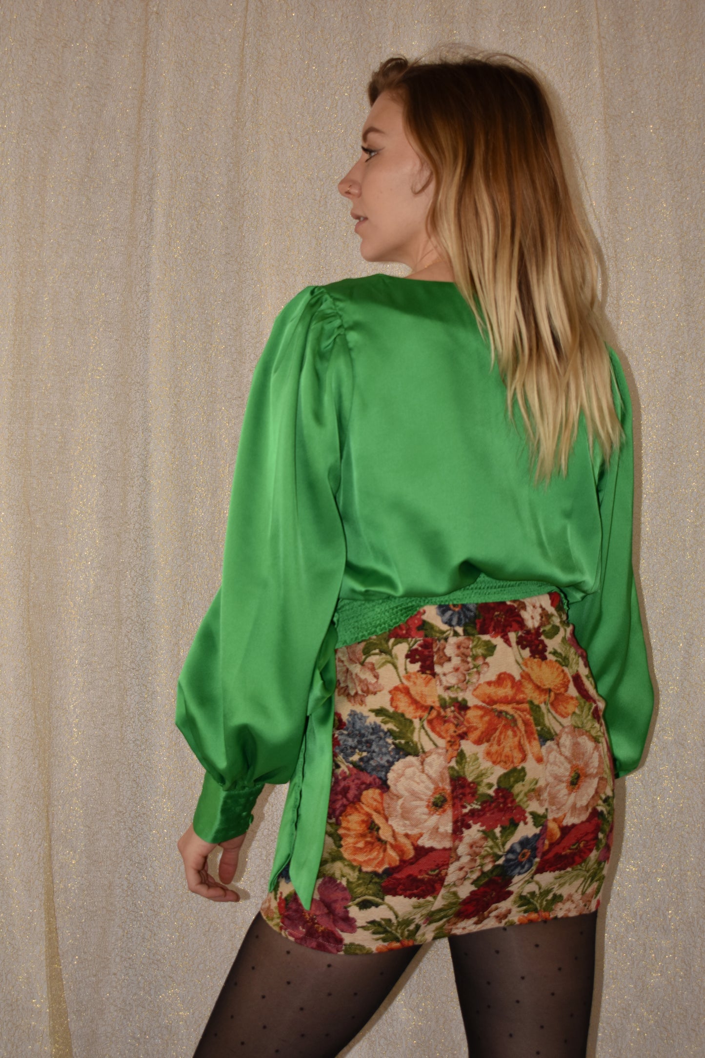 bright green satin wrap top with wrap effect and tie at side waist. cropped with elastic waist on back hem for some stretch. button to keep bust part of shirt enclosed. button cuffs om sleeves. 