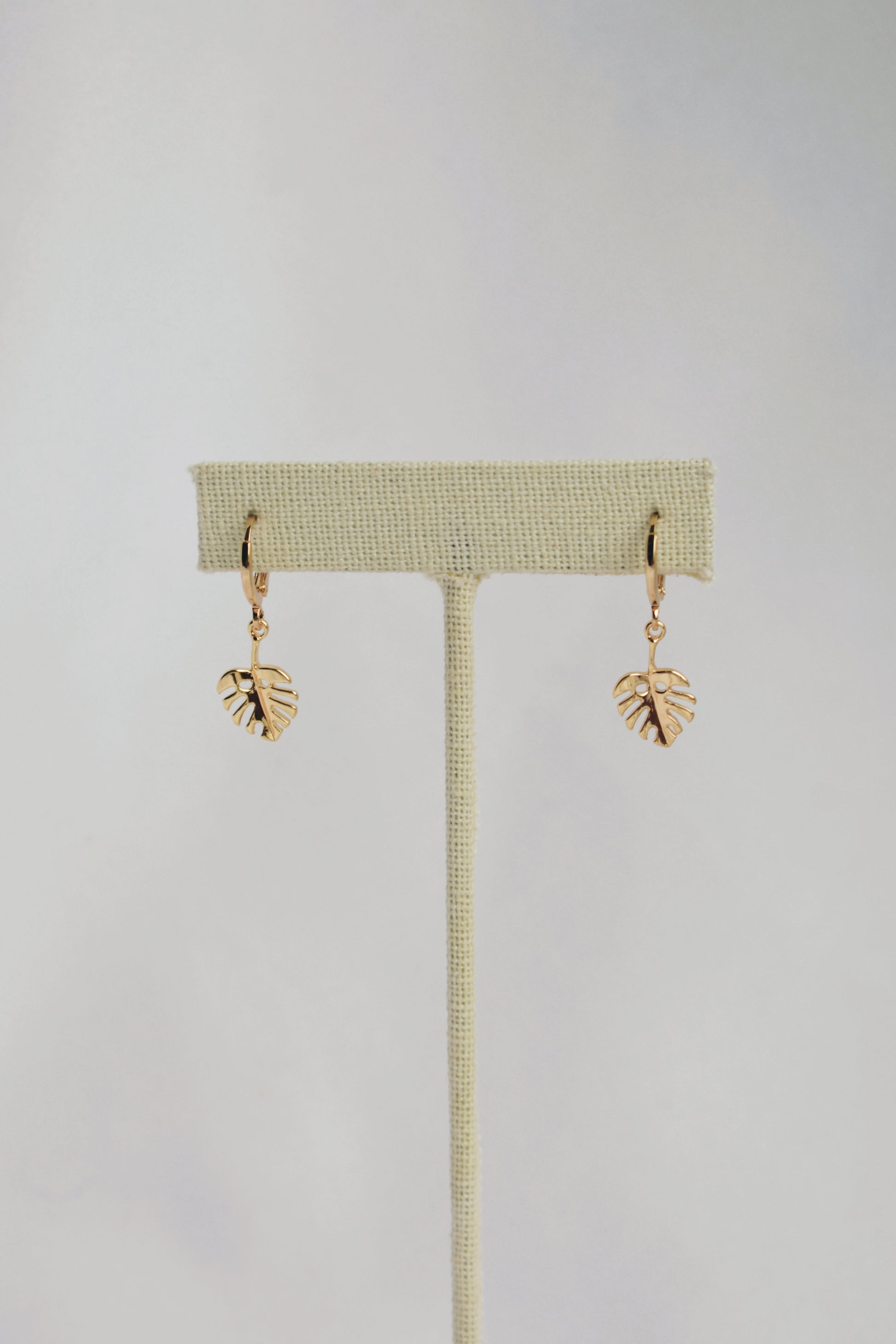 dainty monstera leaf gold plated huggie style hoop earrings