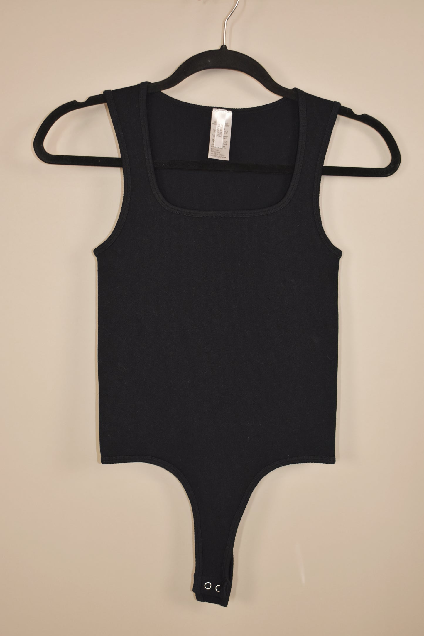 basic scoop neck tank bodysuit thats stretchy and has a snap crotch and a thong bottom