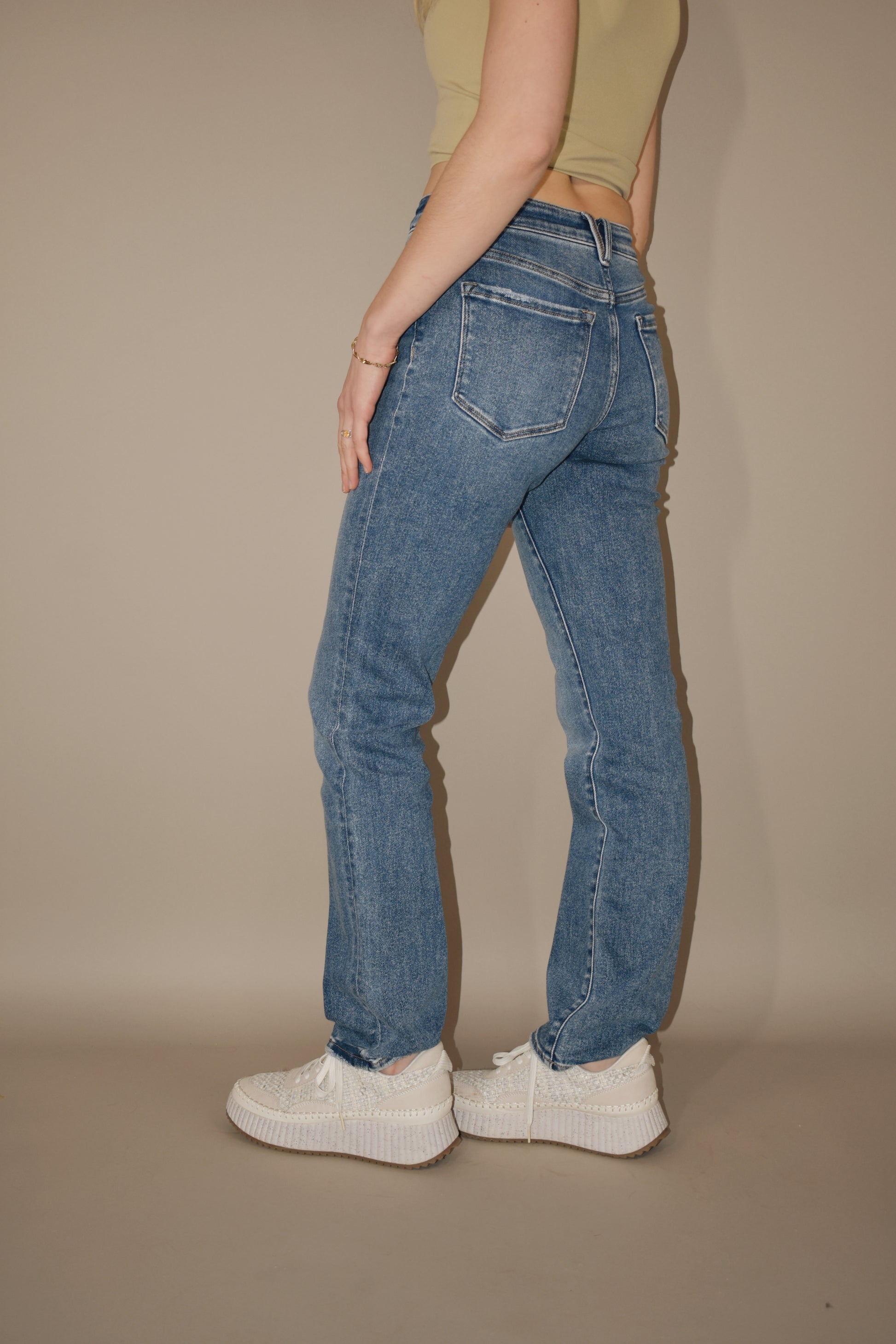 full length stretch denim high rise medium wash jeans. straight leg. no holes. 