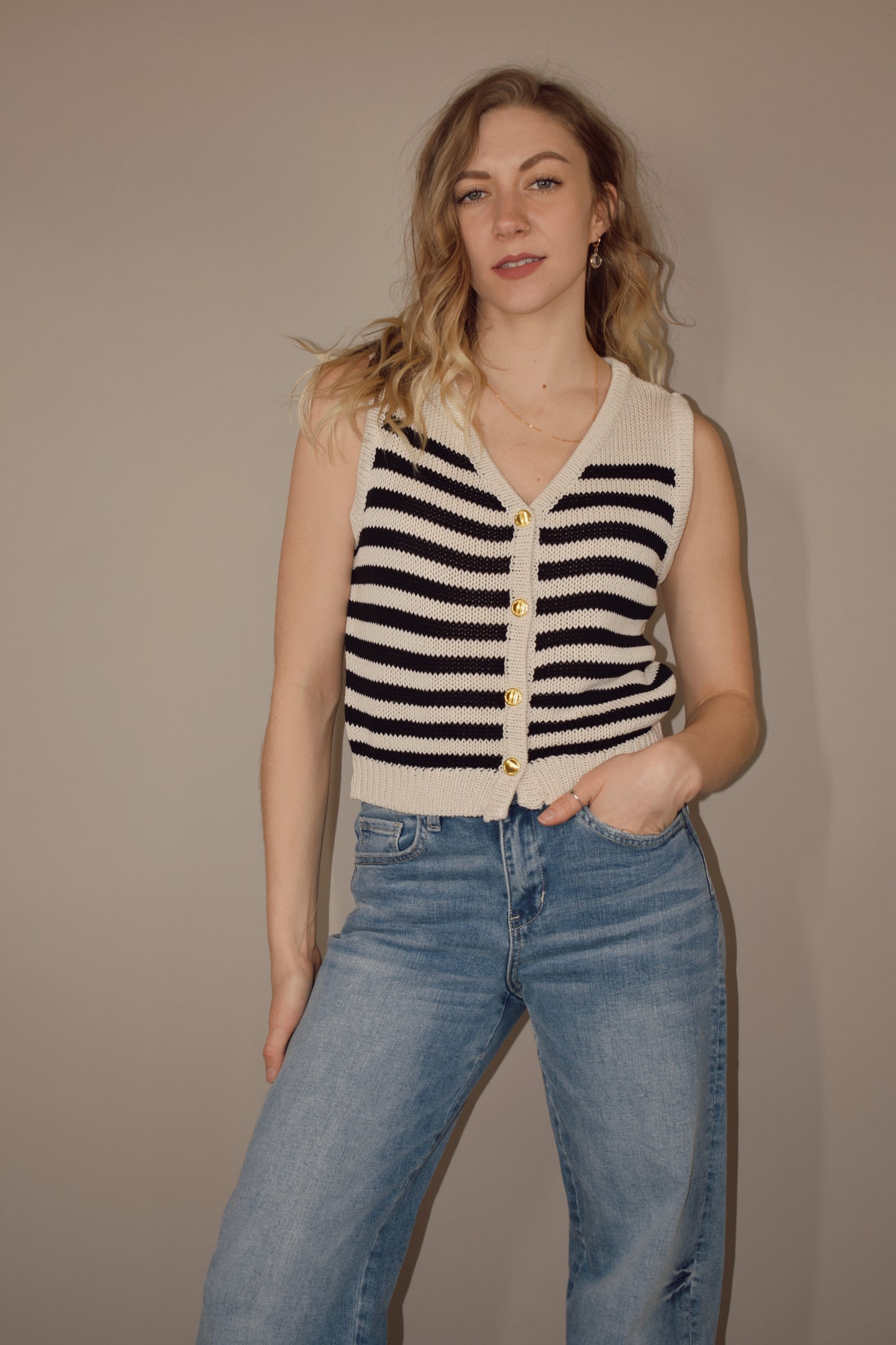striped v neck sweater vest that has gold buttons down the front