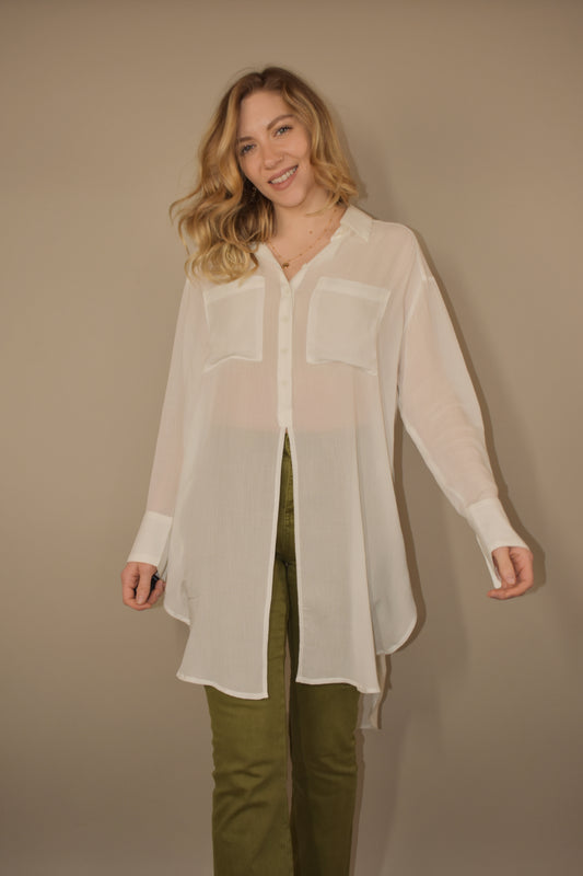 high low effect hem long sleeve flowy button down with two breast pockets and buttons are only on the upper half of the tunic. it hits mid thigh.