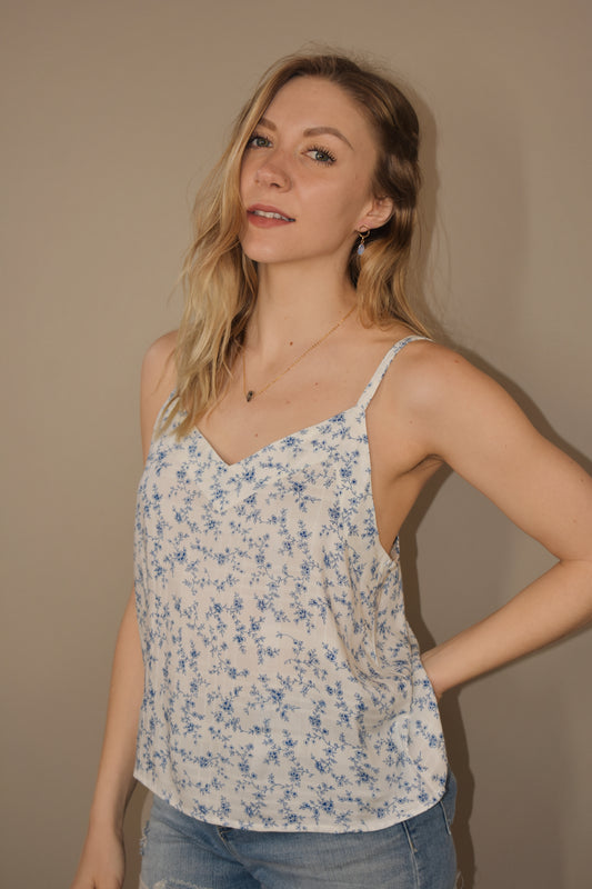 full length loose fitting white cami with dainty blue floral print. adjustable spaghetti straps and v neck.
