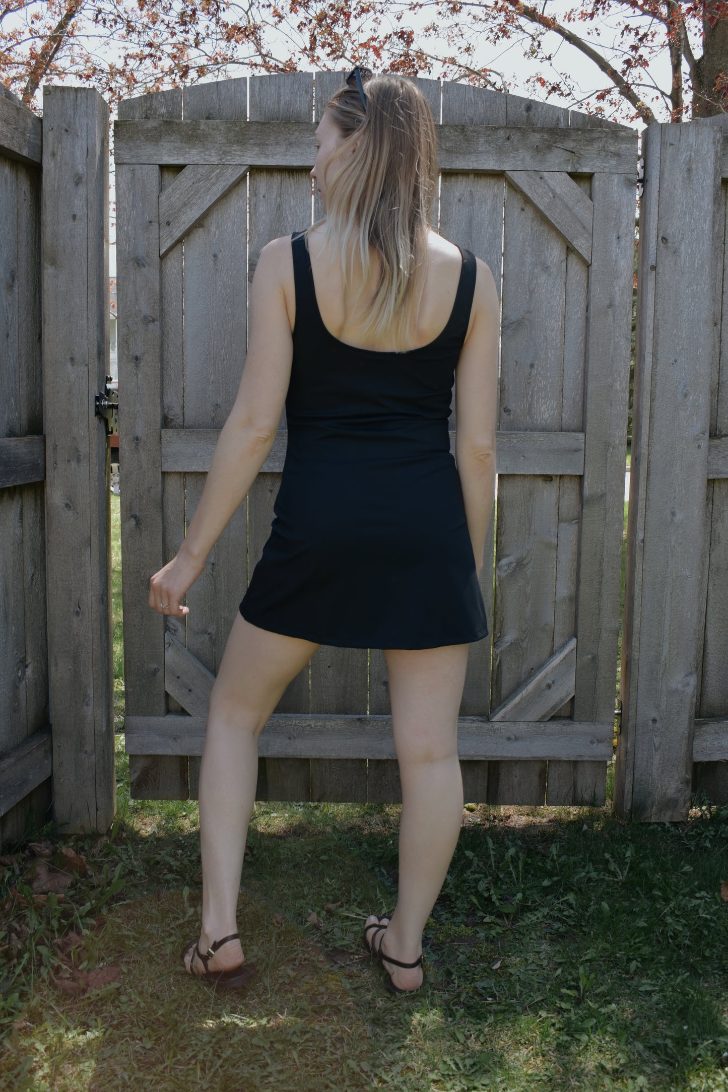 mini tank dress with low scoop back and built in shorts. athletic material.  fitted