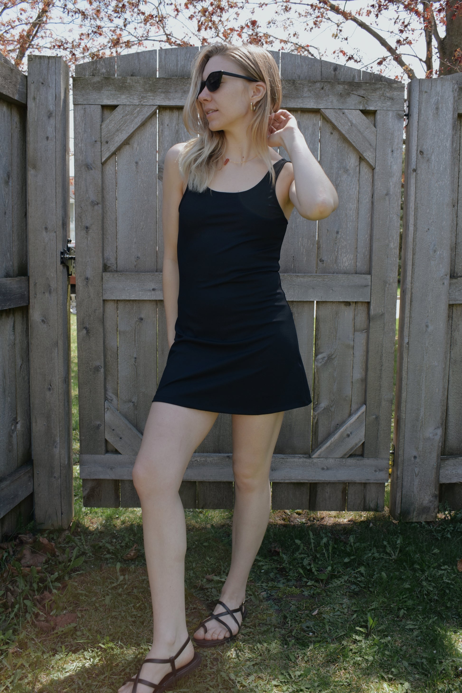 mini tank dress with low scoop back and built in shorts. athletic material. fitted