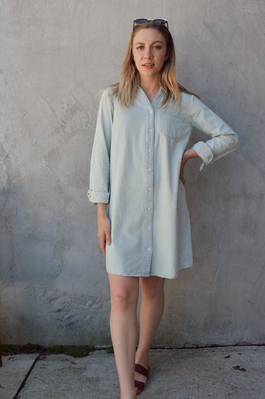 light wash denim dress, mini length, button down, collared, with one breast patch pocket. optional cuff with button 