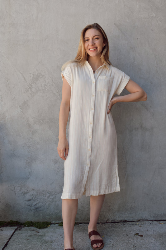 midi length button down cuffed short sleeve shirt dress with vertical pinstripes. one patch breast pocket. very soft and lightweight material.