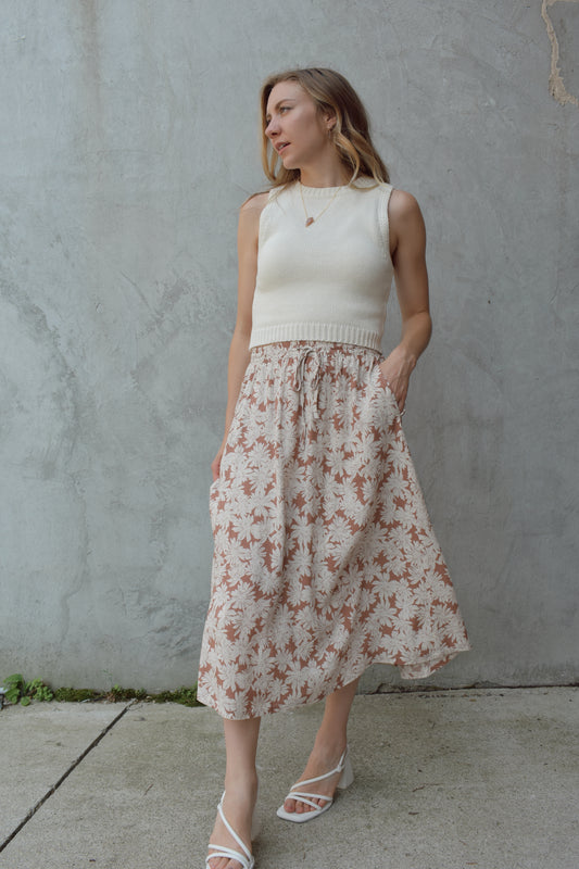 off white and terracotta floral printed linen midi skirt with pockets. elastic waist with drawstring tie. lined and flowy.