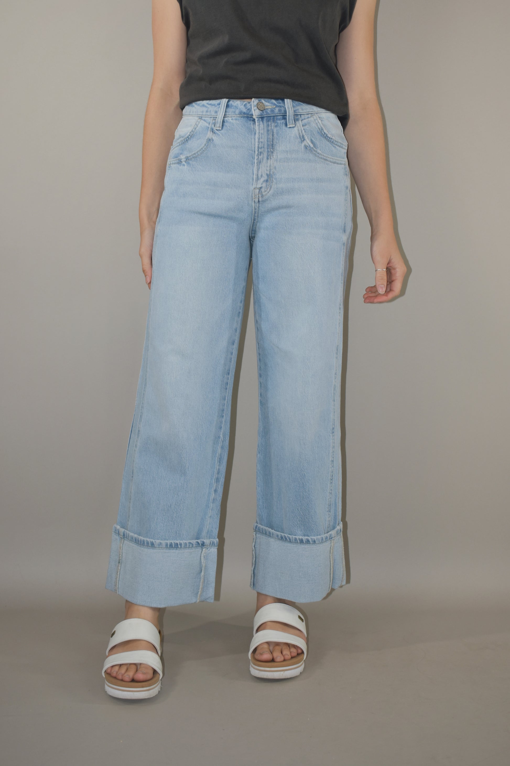 light wash wide leg jeans with large cuff at the hem. no holes or distress marks. double pocket feature in front. stretch denim. has beltloops and back pockets and a zip and button enclosure. high rise. 