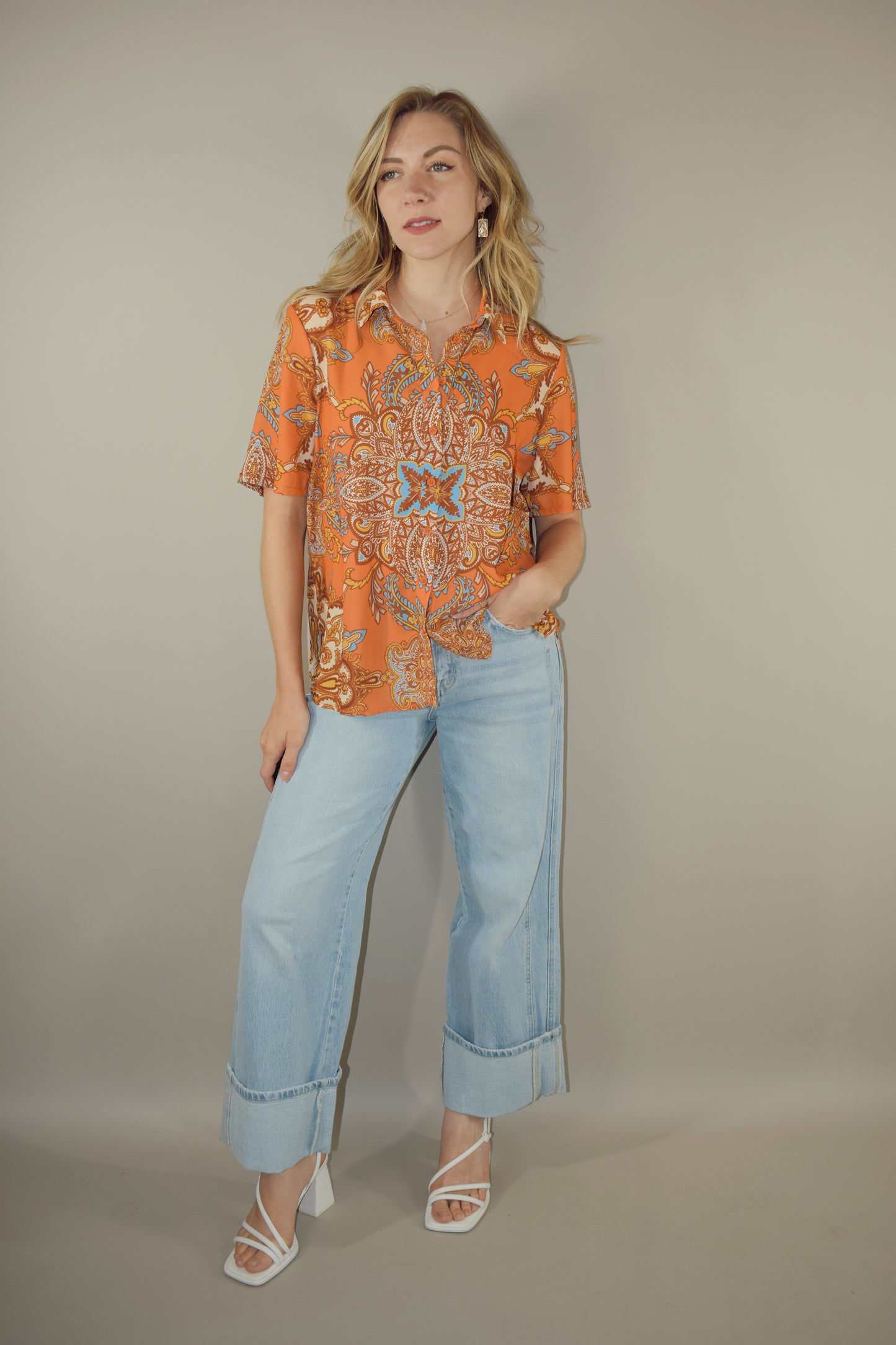 light wash wide leg jeans with large cuff at the hem. no holes or distress marks. double pocket feature in front. stretch denim. has beltloops and back pockets and a zip and button enclosure. high rise. 