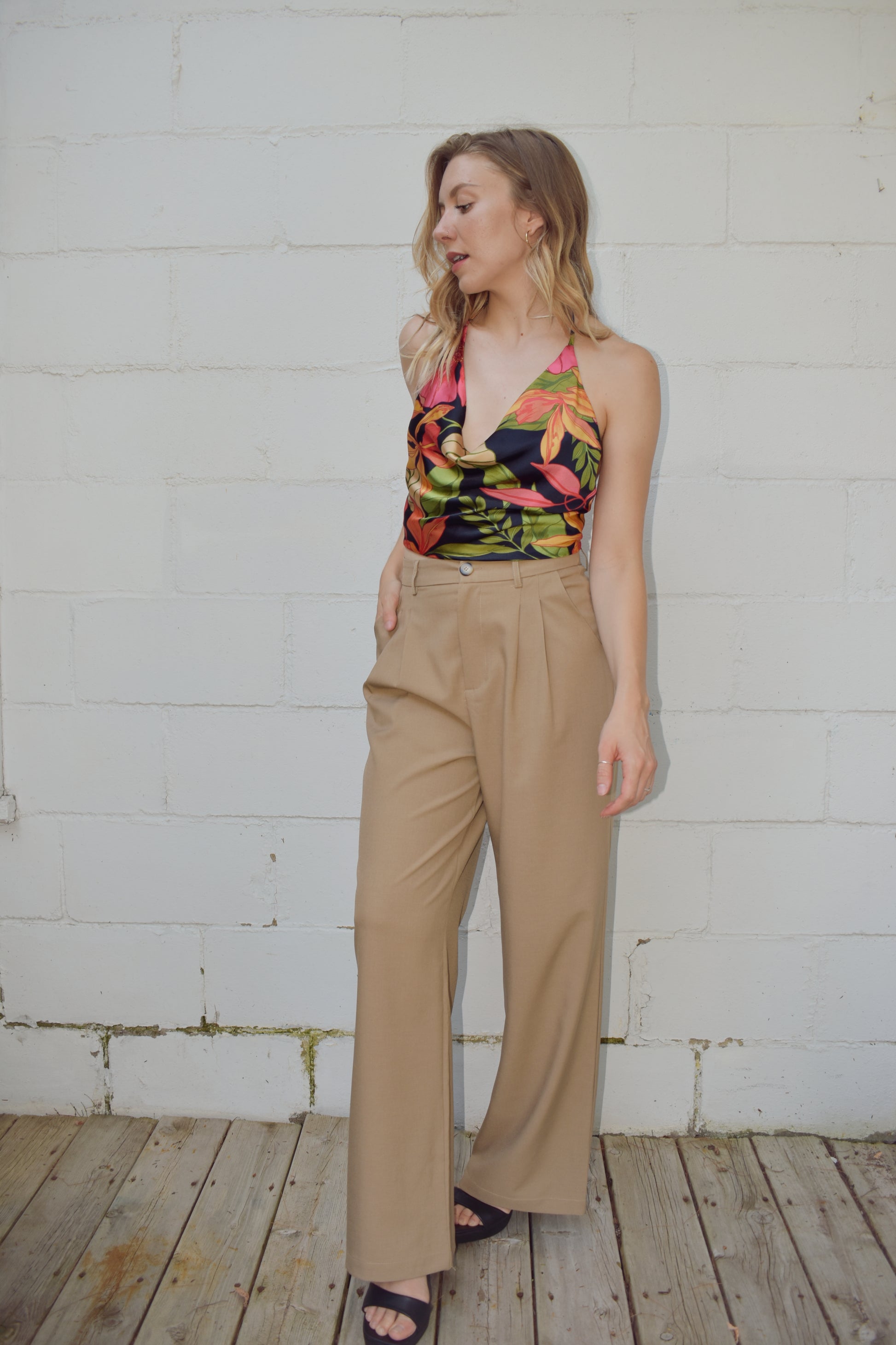 Satin tropical halter top cropped with tie on botton and the neck strap is adjustable. slouchy cowl neck. black background with large colorful botanical print