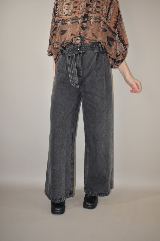 high waisted belted denim trousers wide leg with side pockets, front pleats ,zip and button enclosure, no holes or distressing, grey black wash