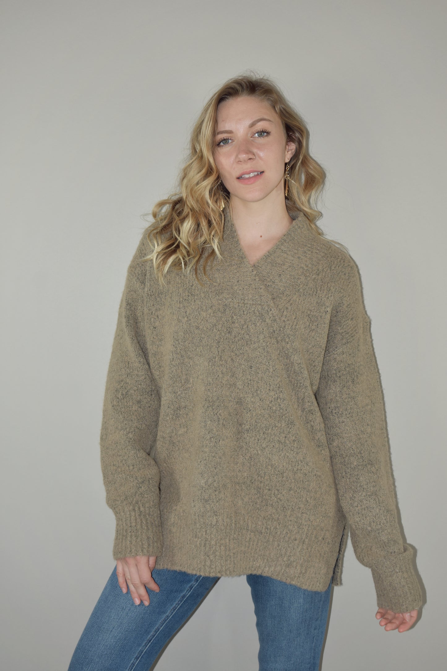 oversized sweater with v criss cross neck with ribbed detailing on neckline, hem and cuffs. two tone knit. side slits on hem