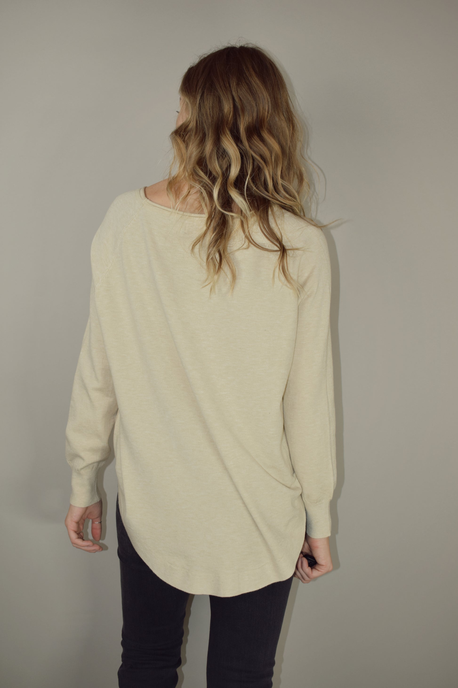 Long boat/crew neck tunic sweater with tight cuffs and scooped hem that comes up on the sides super soft material 