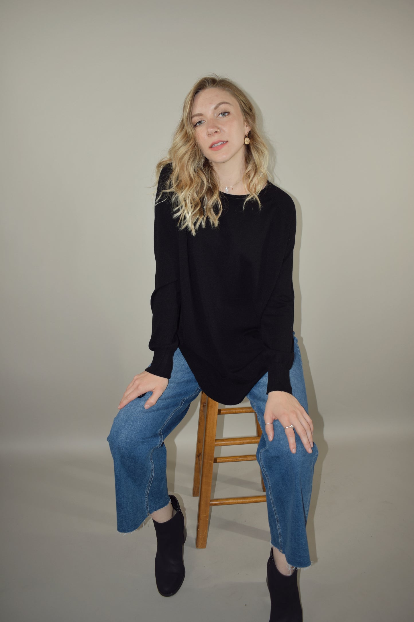 Long boat/crew neck tunic sweater with tight cuffs and scooped hem that comes up on the sides super soft material 