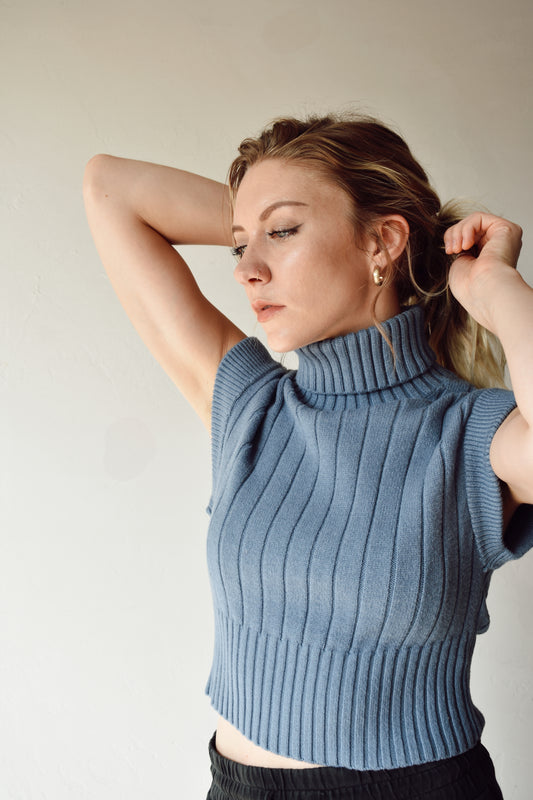 sleeveless ribbed turtleneck with cap sleeves fitted and thicker ribbed pattern on bodice in light blue slightly cropped length