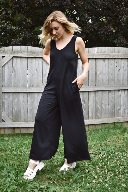 scoop neck tank jumpsuit in black with wide legs and pockets. Made with french terry knit fabric and is loose fitting. The brand is Mittoshop.