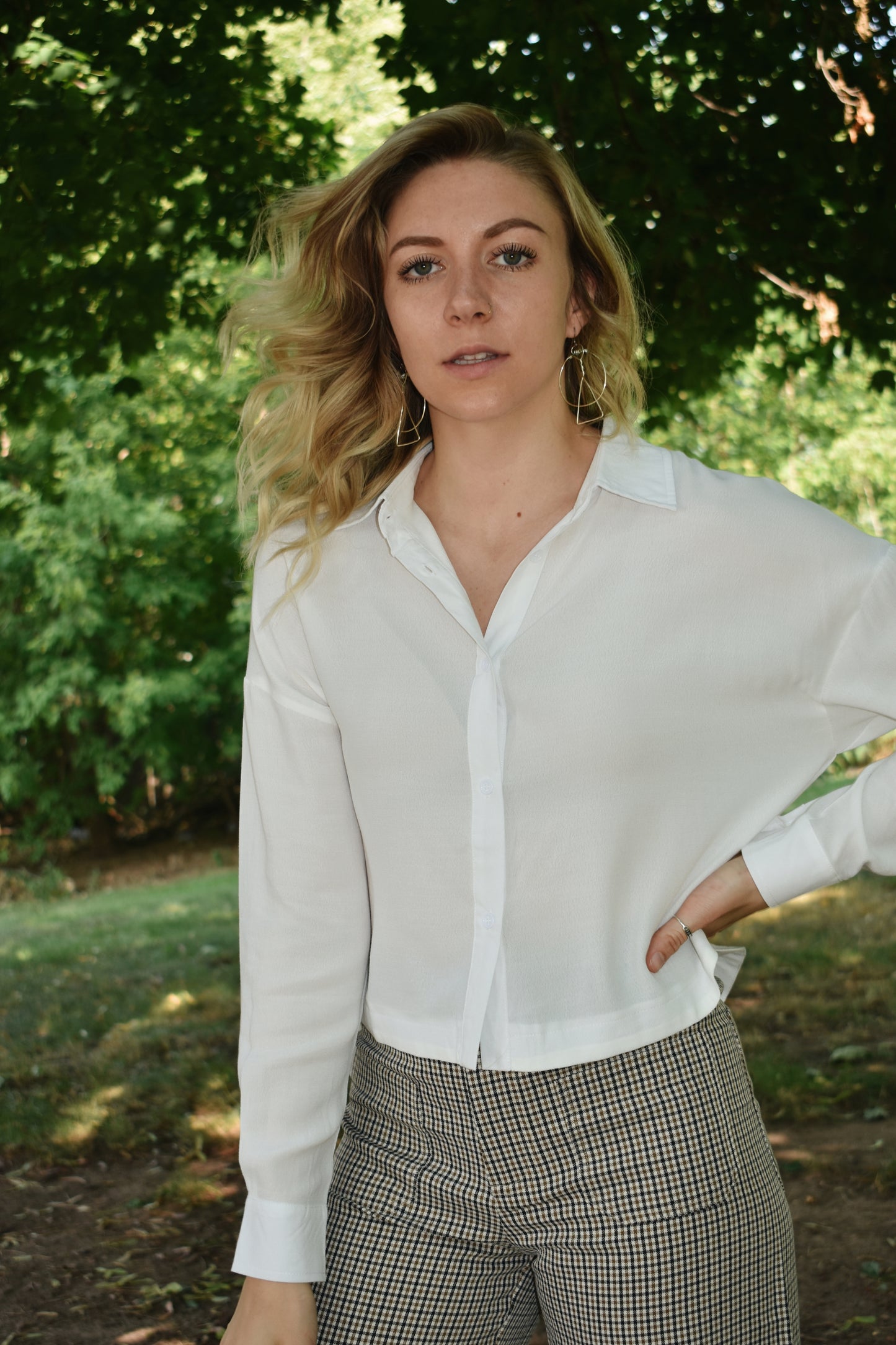 white button down top with cuffed bands and a collar. Placket front with button closure and a cropped length.