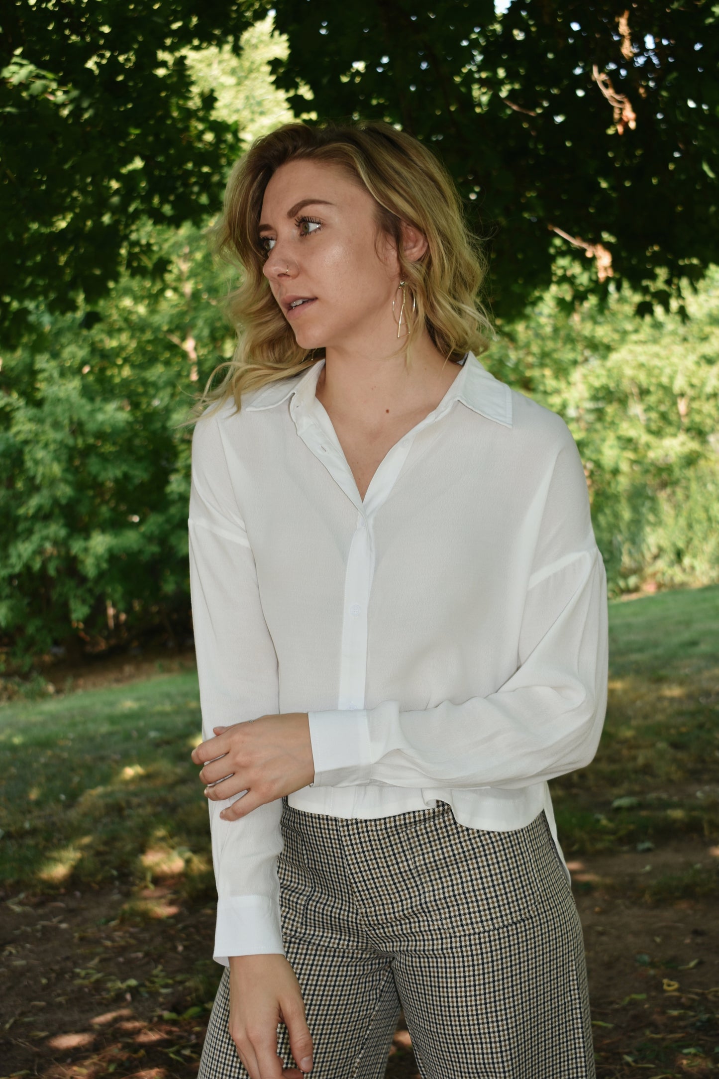 white button down top with cuffed bands and a collar. Placket front with button closure and a cropped length.