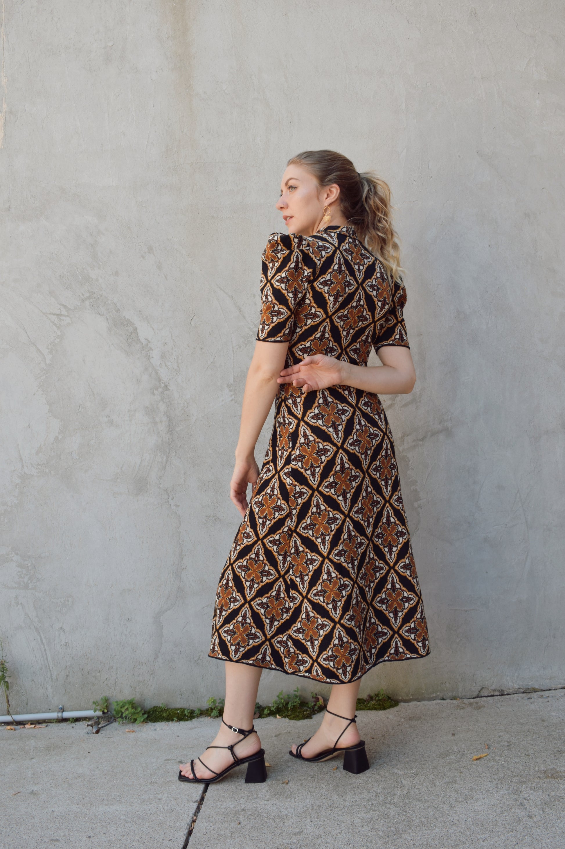 ornamental jacquard sweater midi dress, fitted through bodice and hips, A line skirt, high neck, stretchy, short sleeves that hit at low bicep with puff shoulder structure.