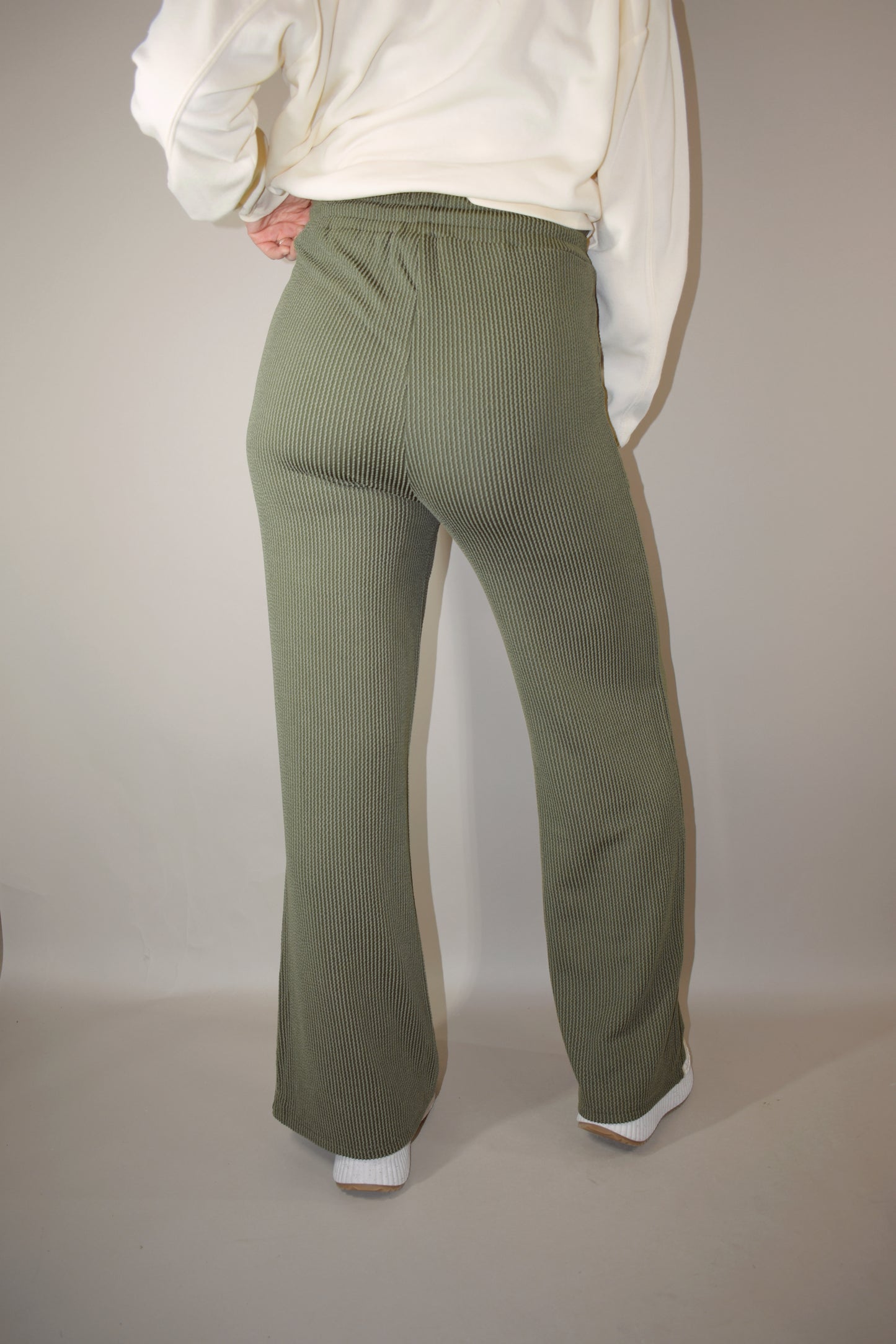 full length high waisted wide leg ribbed olive green athleisure pants with elastic waistband, drawstring, and front pockets.