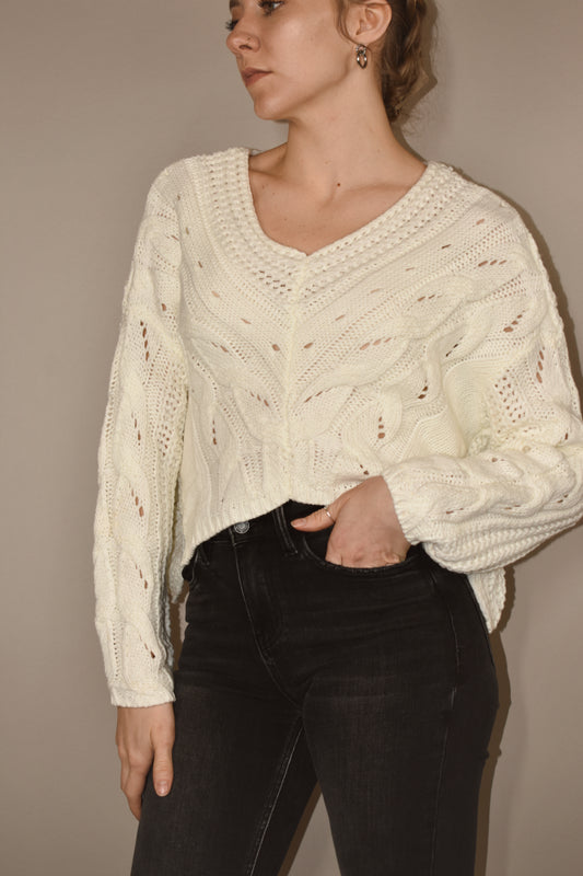 cable knit cropped white sweater with beautiful v neck detailing and the hem is an upward v - sides have a slight slit