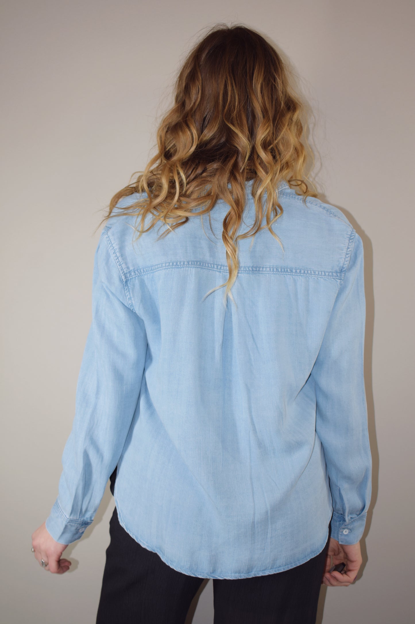 Tencel light wash denim long sleeve button down with one breast patch pocket full length