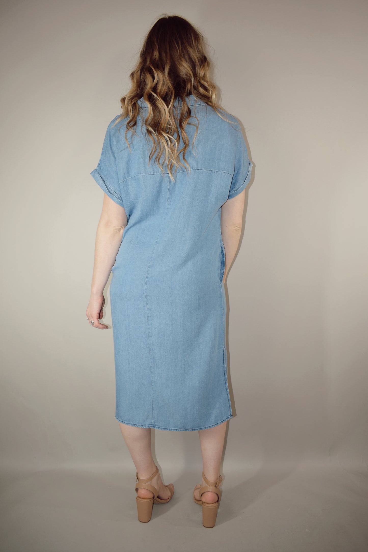 Tencel medium wash denim button down collared t shirt midi dress with side slits, side pockets, cuffed short sleeves