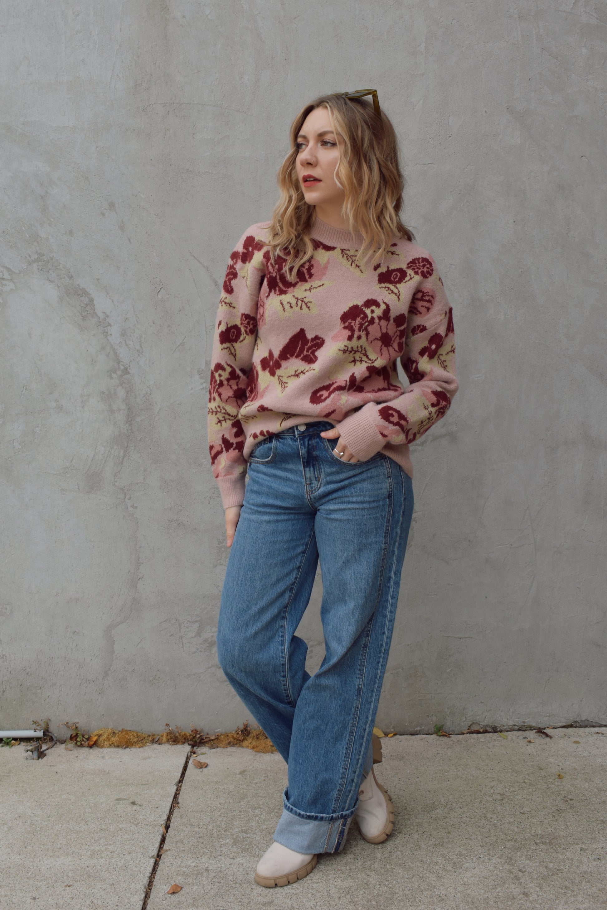 crew neck sweater full length relaxed fit drop shoulder with dusty rose background and floral and leaf design in shades of red pink and light green 