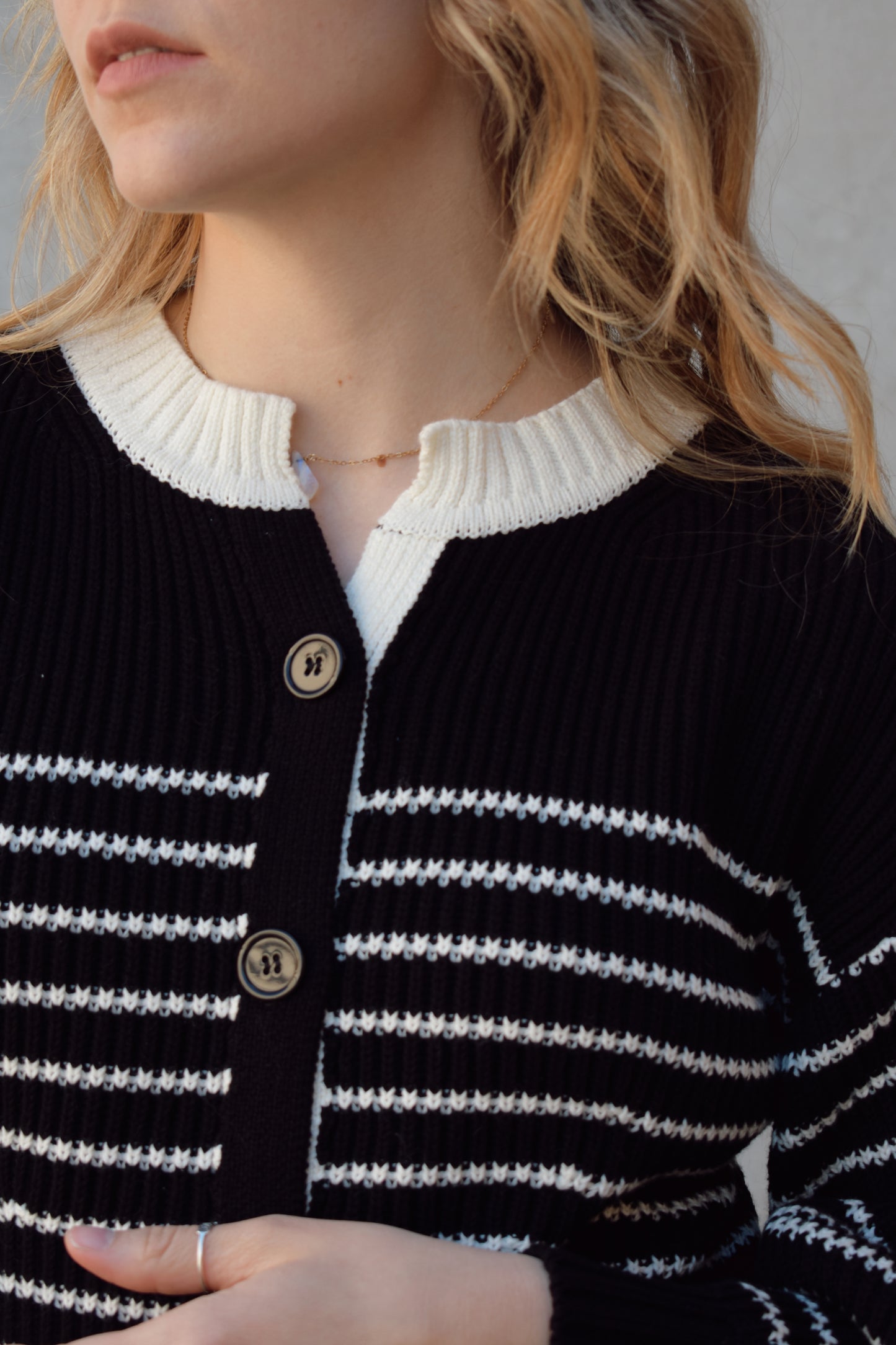 black and white button down cardigan with horizontal stripes drop shoulder balloon sleeves straight fit full length solid white neckline solid black cuffs and hem