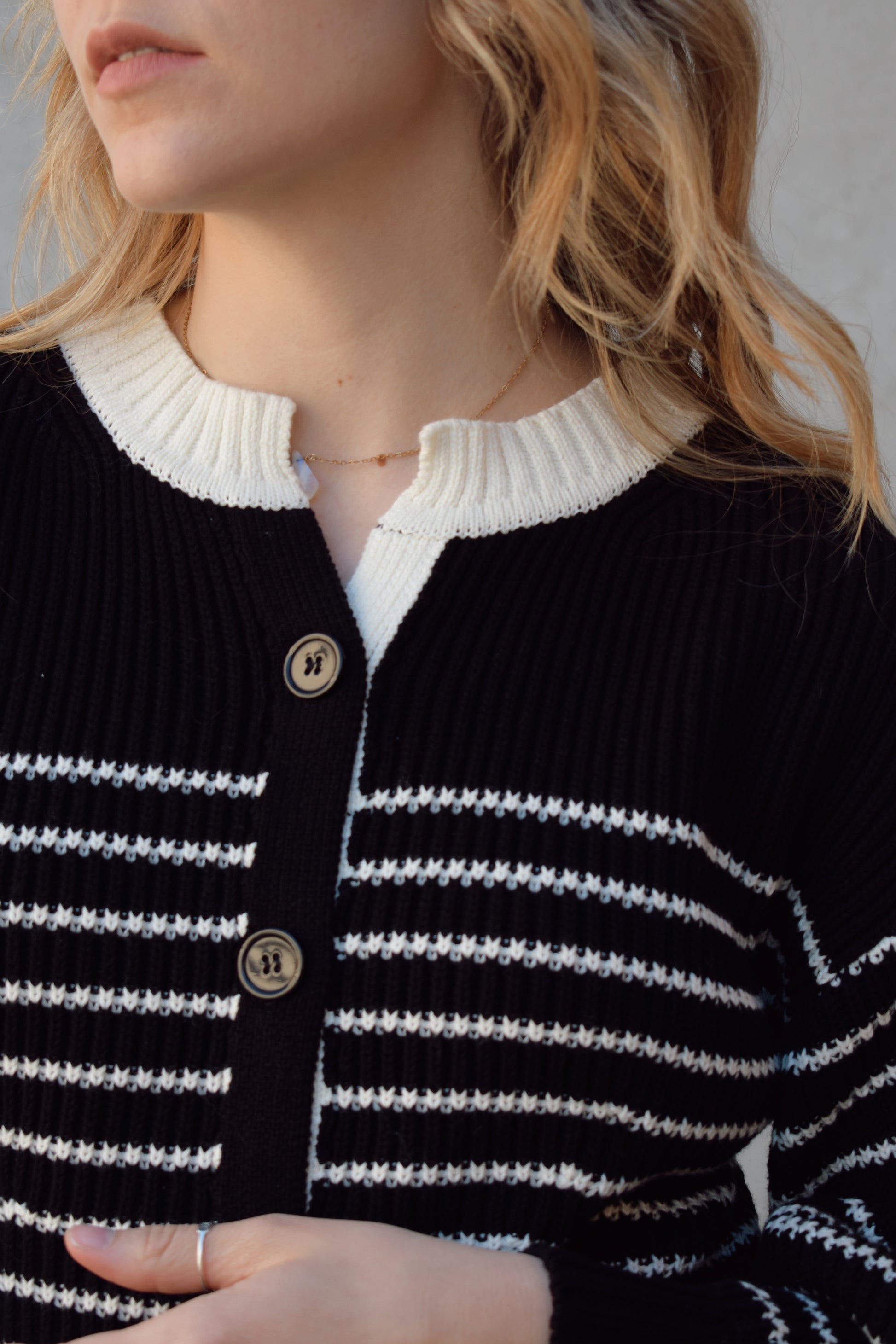 black and white button down cardigan with horizontal stripes drop shoulder balloon sleeves straight fit full length solid white neckline solid black cuffs and hem
