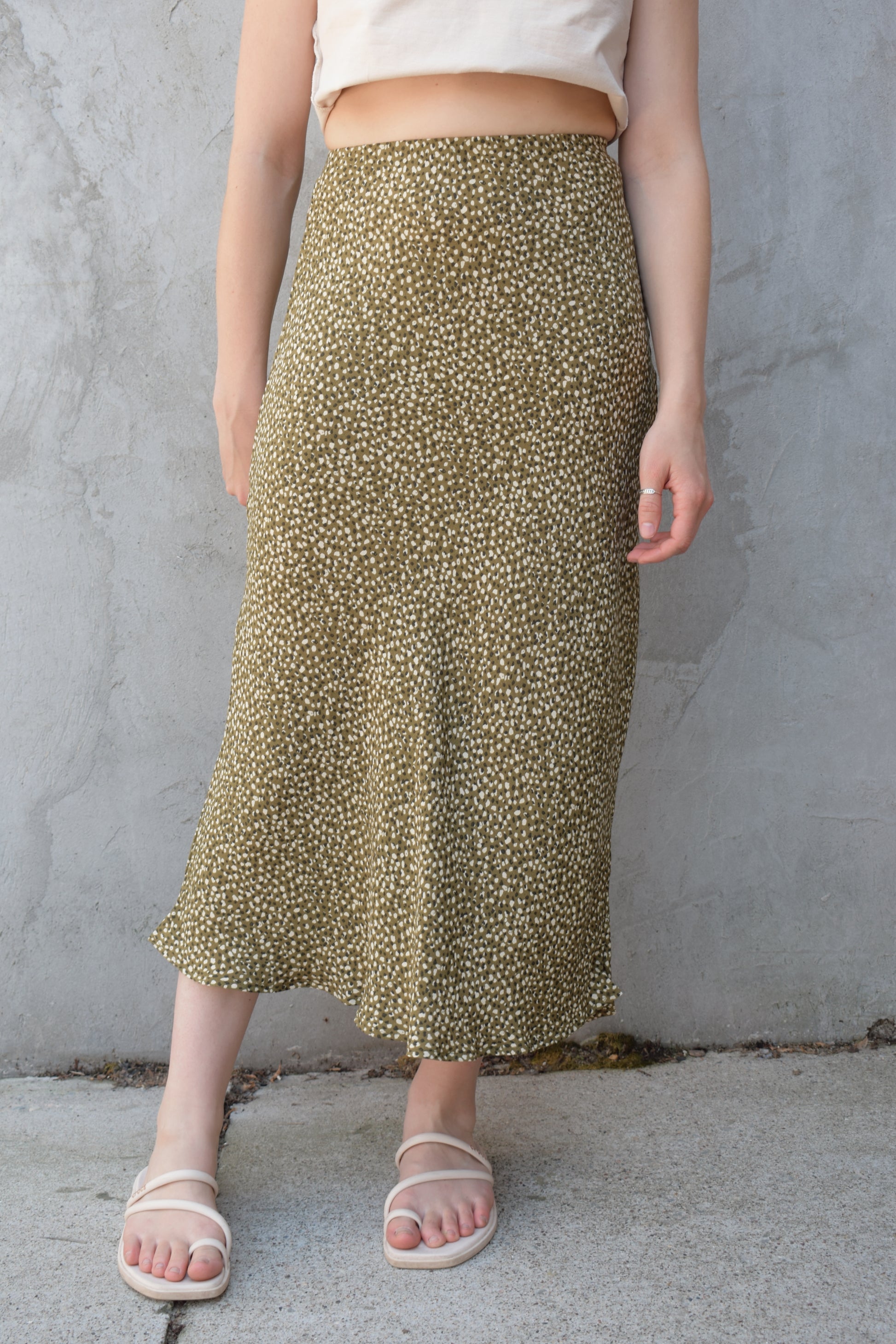 lightweight midi skirt with elastic waistband, no pockets, olive green background with black and cream dotted pattern