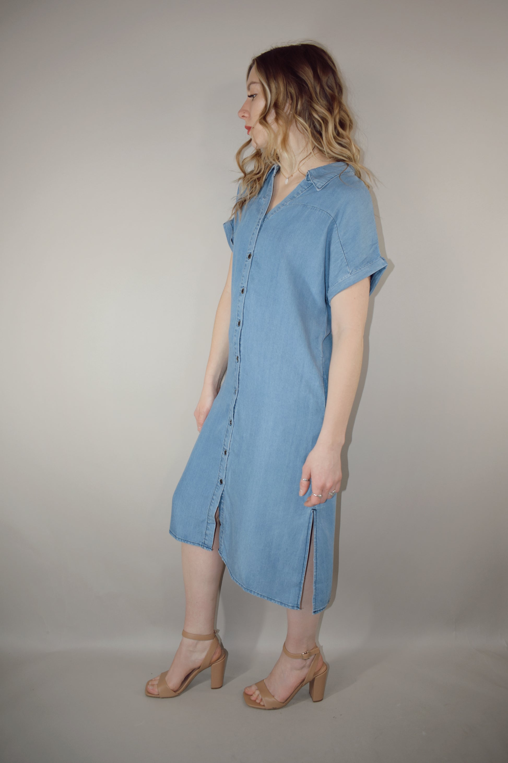 Tencel medium wash denim button down collared t shirt midi dress with side slits, side pockets, cuffed short sleeves