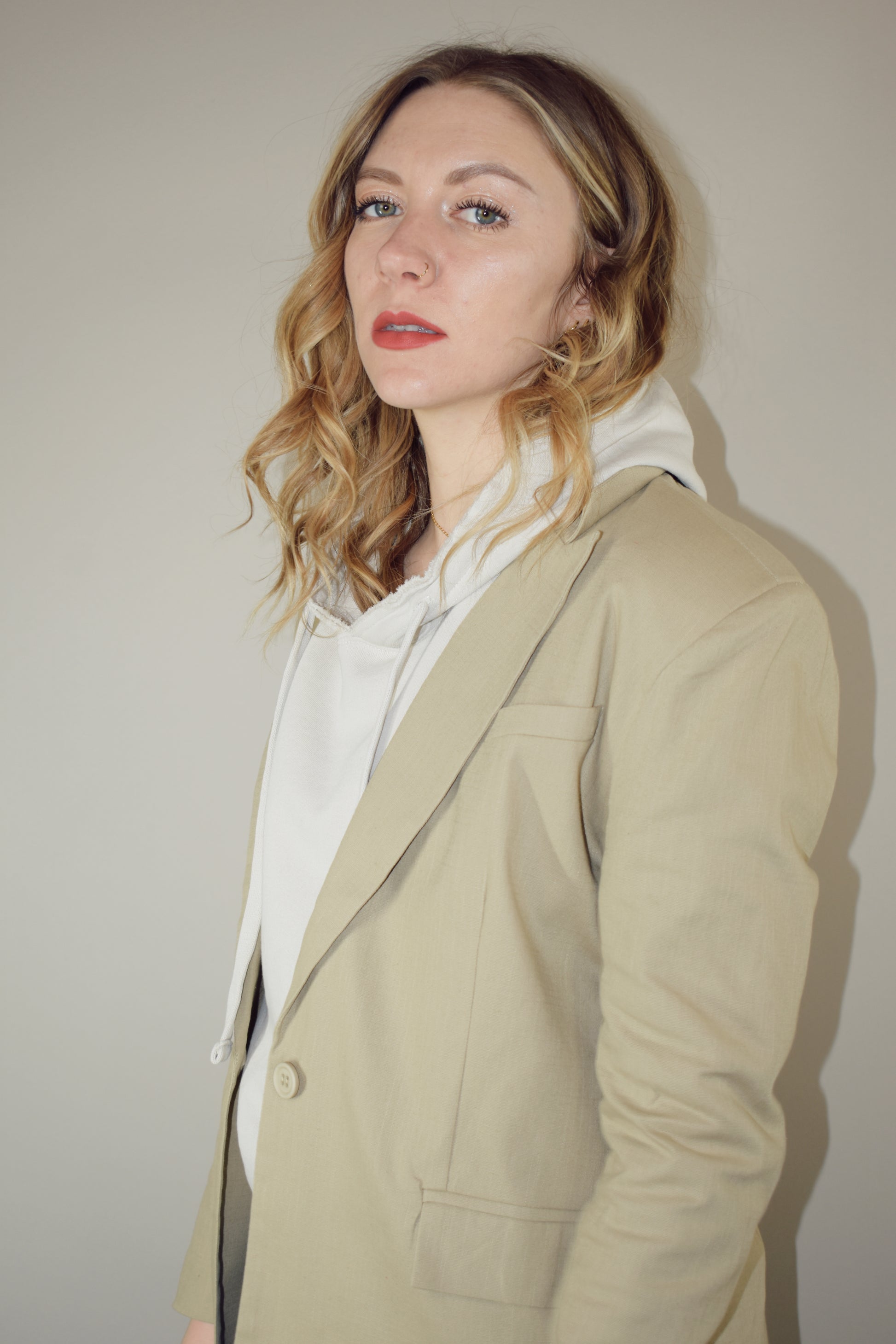 nude linen blazer full length front pockets with flap enclosure single button enclosure slit in back hemline relaxed shoulder pad structure