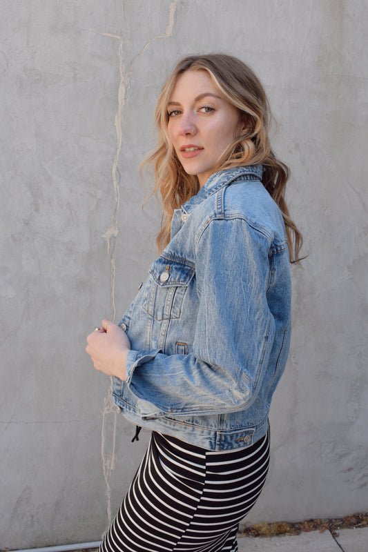 medium wash distressed jean jacket staple for wardrobe relaxed fit full length