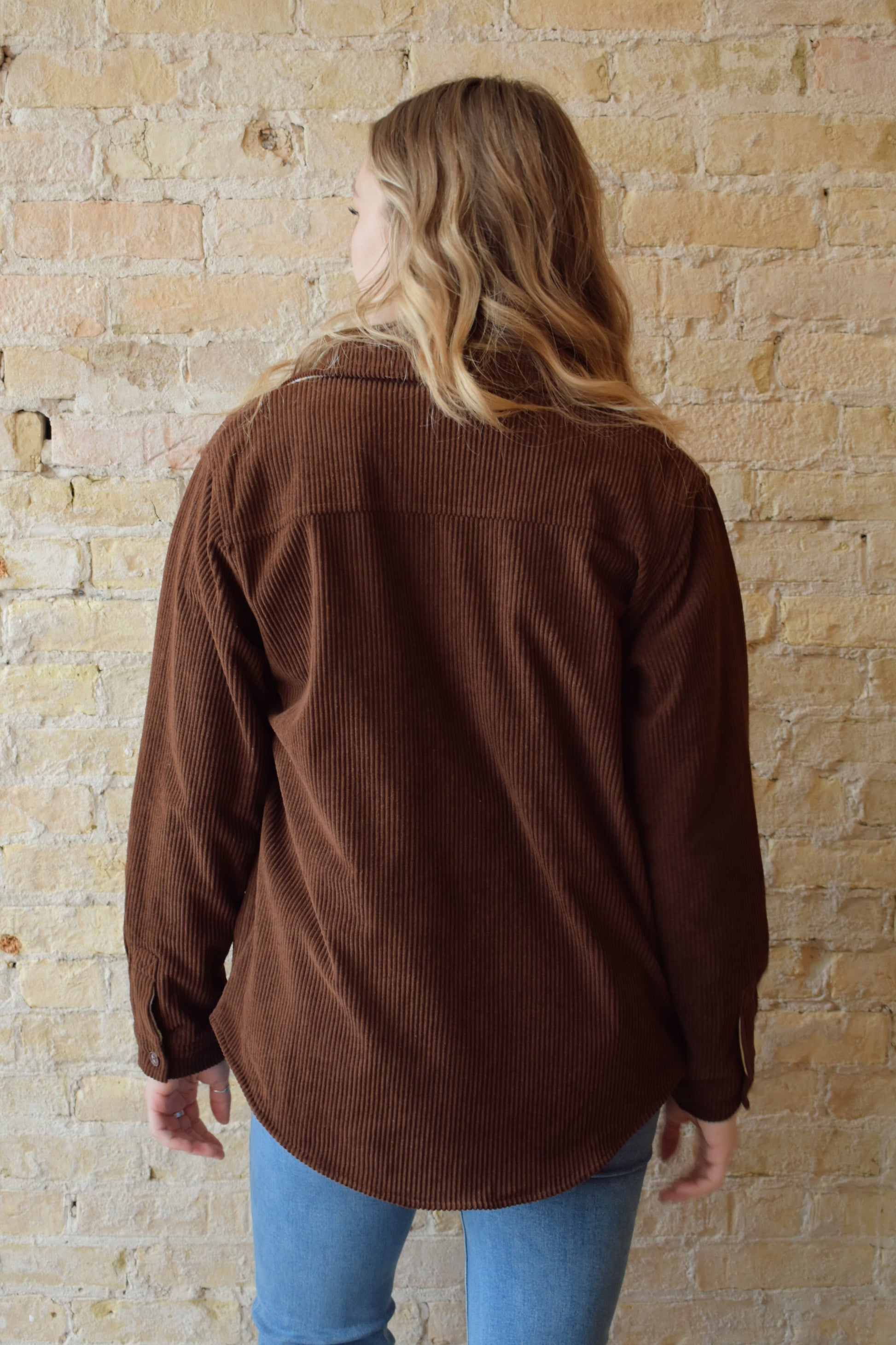 dark brown corduroy shacket lined with mustard color plaid flannel, reversible, one side has breast pockets the other has side front pockets, button down, relaxed fit full length