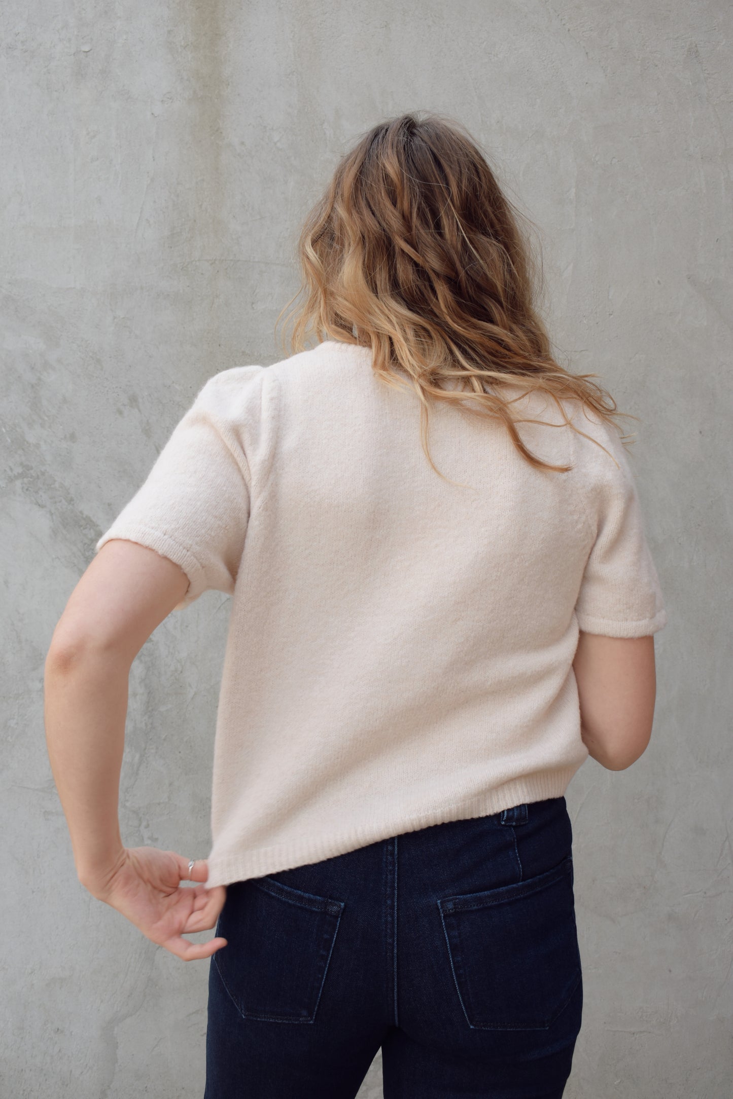 short sleeve cardigan sweater with crew neckline and slight puff sleeves gathered at shoulder, ribbed hem, straight fit, hits at waistline