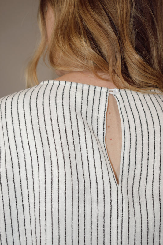 vertical striped short sleeve dolman top slightly cropped relaxed fit one patch breast pocket eyelet enclosure on back neckline