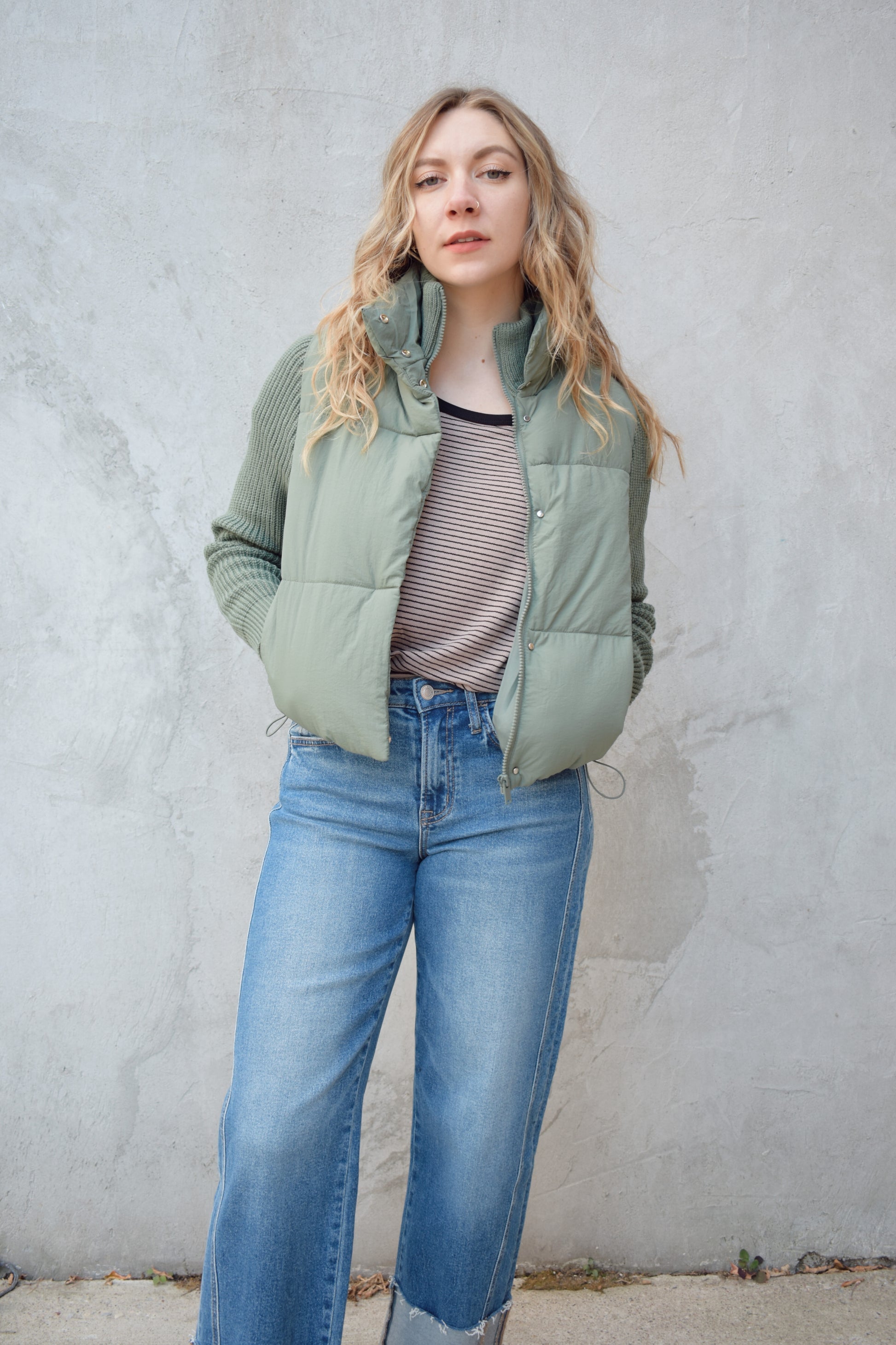 blue green puffer jacket with ribbed knit sleeves, zip and snap front enclosure, has double collar with both materials, has pockets, sinch band at hem