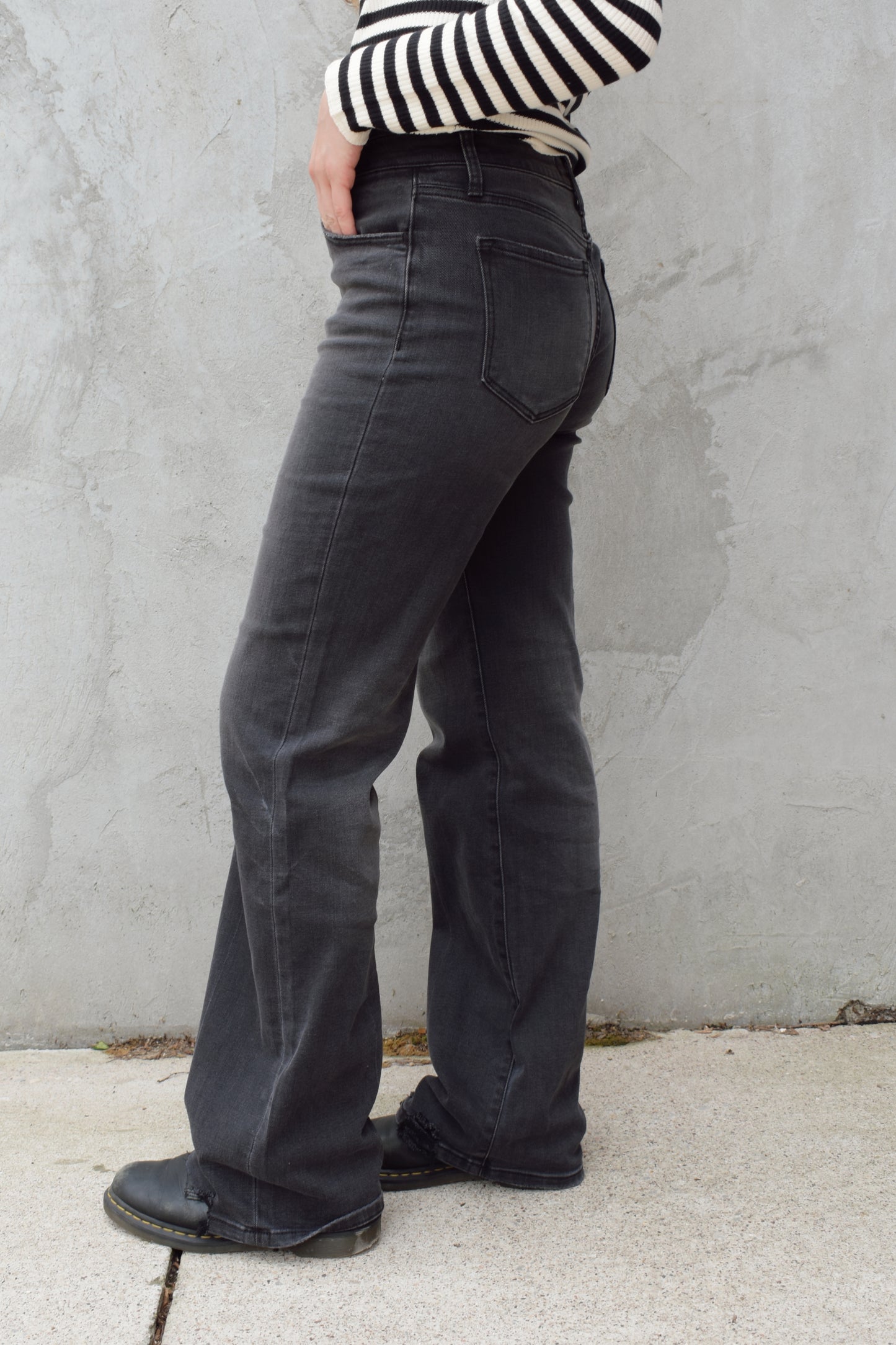 high rise washed black wide leg flare jeans full length stretch denim distressed hem but no holes zip and button enclosure has beltloops has front and back pockets 