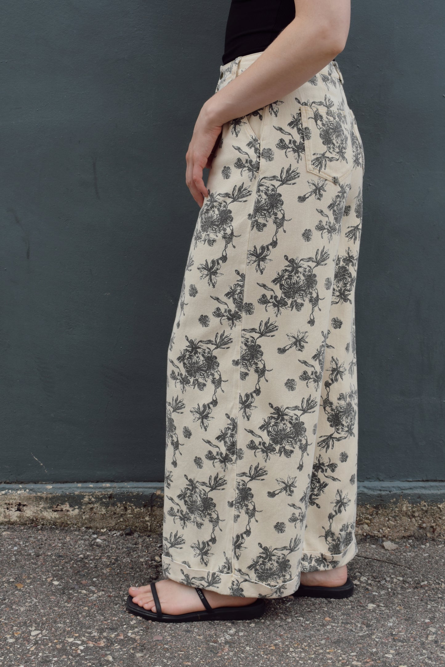 cream wide leg trousers with slate blue floral pattern, zip and button enclosure, front and back pockets, has beltloops, cuffed hem, high rise, statement pants, 100% cotton