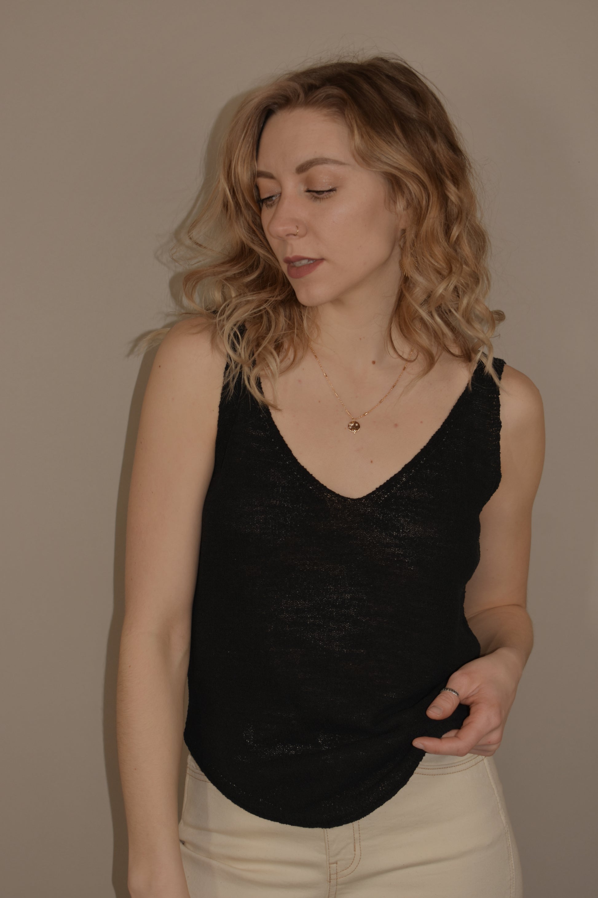 thin and lightweight sweater tank with v neck and rounded hem. full length. relaxed fit.