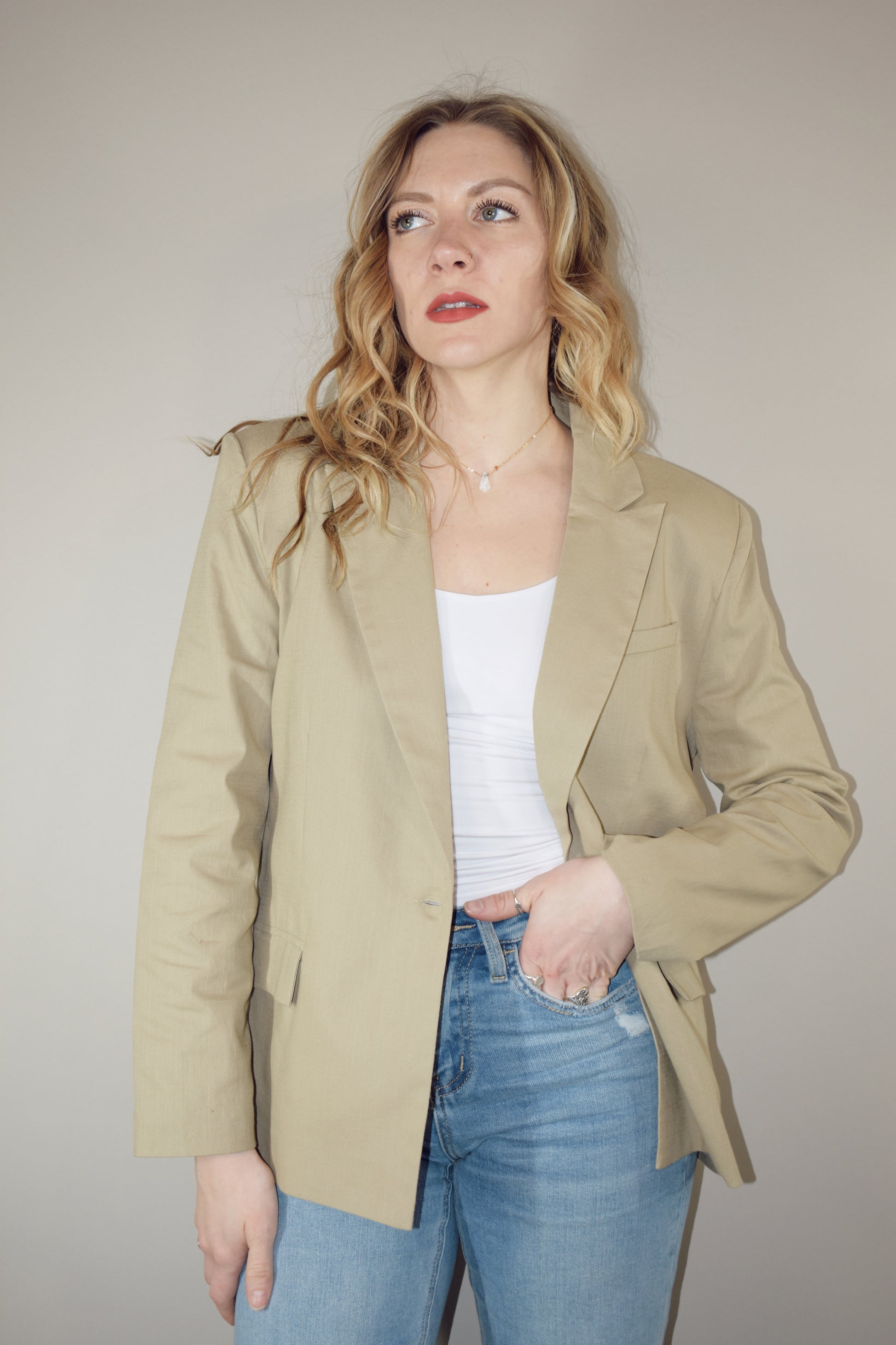 nude linen blazer full length front pockets with flap enclosure single button enclosure slit in back hemline relaxed shoulder pad structure