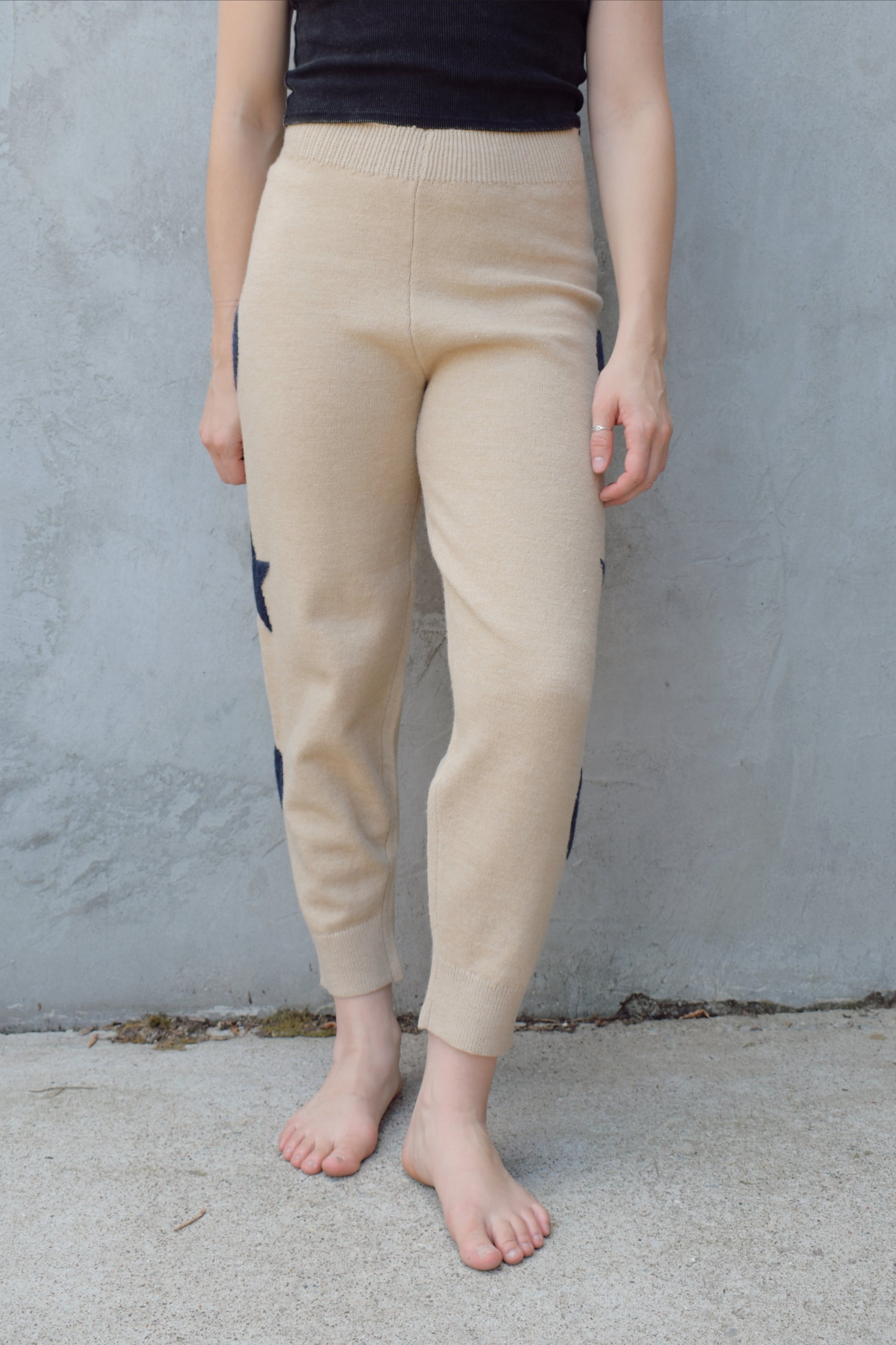 cream knit joggers with slightly elastic wide waistband, high waisted, moon and star design on sides of leg, relaxed fit, no pockets