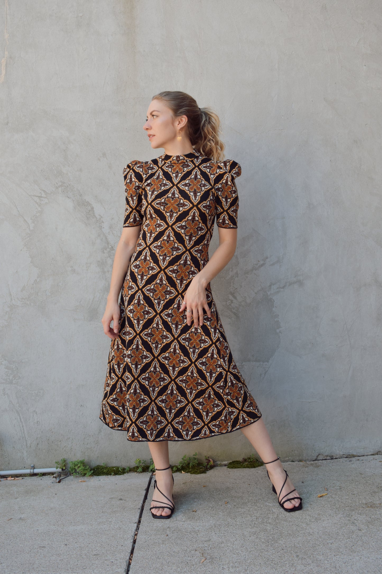 ornamental jacquard sweater midi dress, fitted through bodice and hips, A line skirt, high neck, stretchy, short sleeves that hit at low bicep with puff shoulder structure.