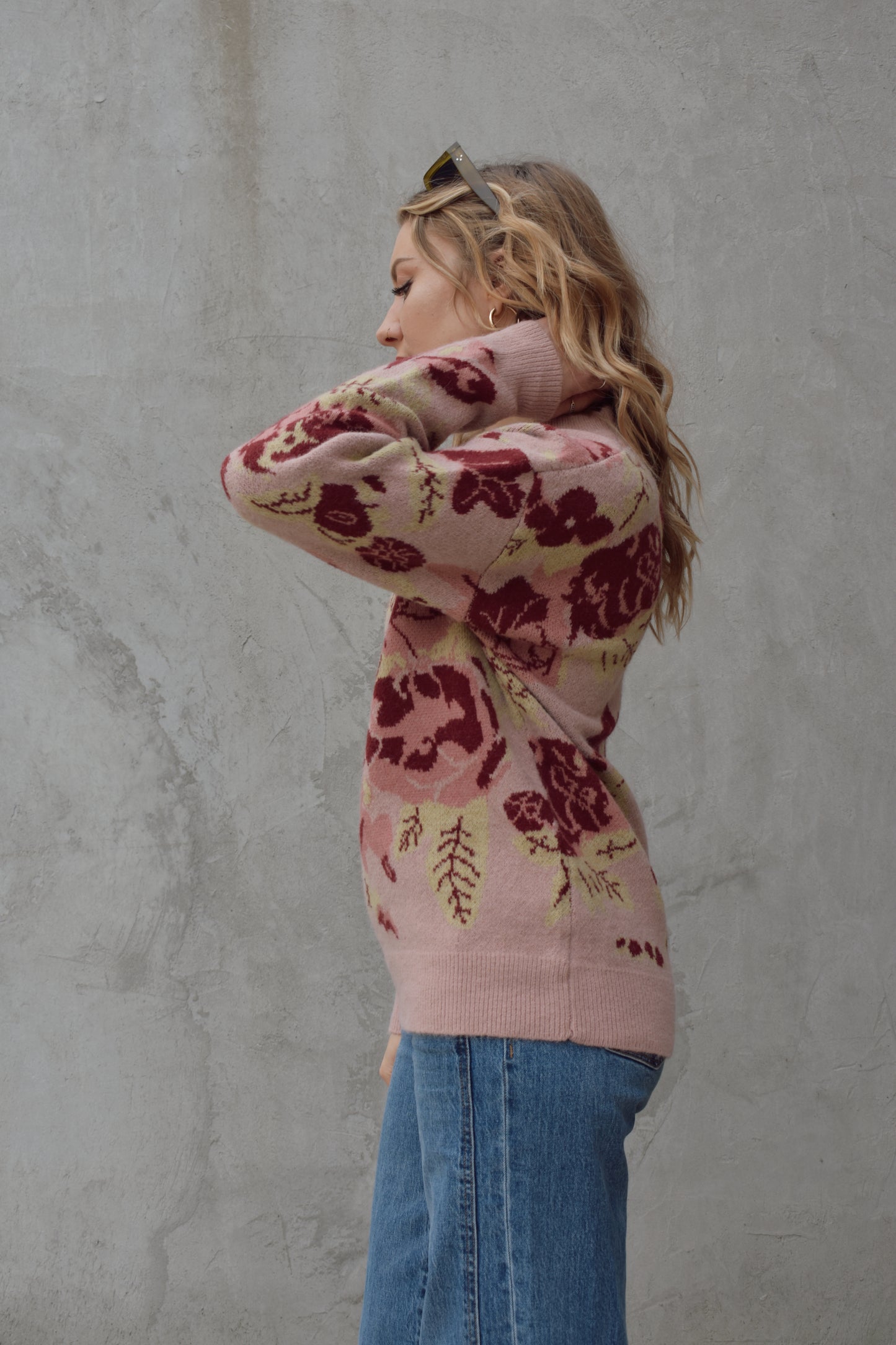 crew neck sweater full length relaxed fit drop shoulder with dusty rose background and floral and leaf design in shades of red pink and light green 